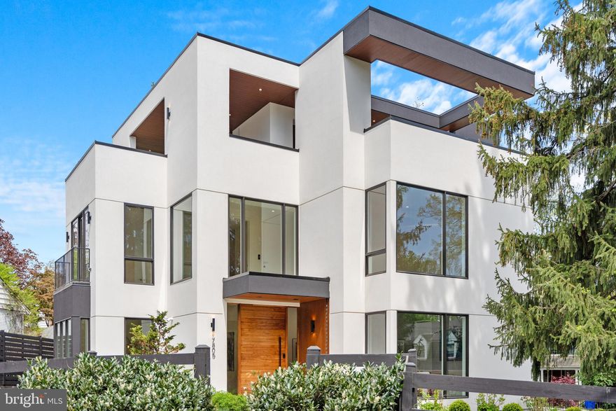 INCREDIBLE NEW PRICE! A contemporary oasis in an urban setting, 7805 Moorland Lane masterfully blends cutting-edge design, expert craftsmanship, and luxurious finishes. Built by CoreBuild+ and designed by GTM Architects, the newly built home includes 6 Bedrooms, 6 Full Baths, 5,760 total SF, elevator to all levels, 10’ main level ceilings, and perhaps the largest private roofdeck in Bethesda! The Bauformat German kitchen features Miele Appliances, Dekton Countertops, sleek European cabinetry, and an accompanying walk-in pantry and bar that leads to the Dining Room. The grand Living Room with fireplace opens to the rear garden and covered deck. An Office/Bedroom and en suite Bath complete this level. Accessible via elevator or the grand staircase, the primary suite offers a tranquil retreat, complete with a spa-inspired bath featuring dual floating vanities, a freestanding soaking tub, and an oversized walk-in shower. Two additional bedroom suites share the upper level, while the top floor hosts a private penthouse suite with terrace access. The roofdeck is a showstopping retreat with shaded lounge, linear fireplace, and dining area, which provide seamless indoor-outdoor living and breathtaking views of Bethesda’s skyline. The lower level includes a two-car garage, a full mudroom, recreation room, and an additional bedroom suite. Integrated smart home technology, including built-in surround sound and cutting-edge AV systems, enhances both functionality and comfort. Located near Downtown Bethesda, the home has easy access to all of the restaurants and retail along Wisconsin Avenue, the Edgemoor Club, Kenwood Country Club, Chevy Chase Club, and NIH. Zoned for Bradley Hills ES, Pyle MS, and Walt Whitman HS.
