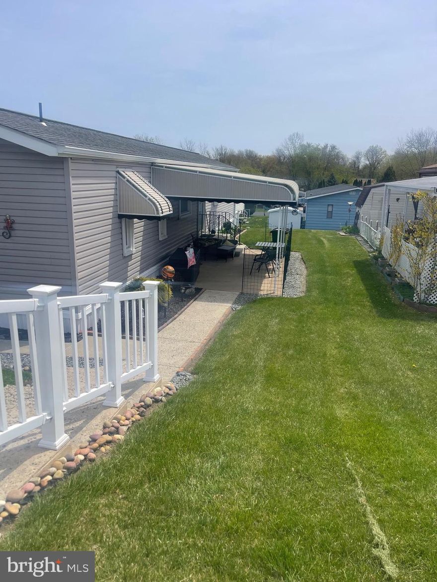 Welcome to this charming and beautifully updated manufactured home, nestled in a serene 55+ community! Thoughtfully designed for comfort and ease, this cozy yet efficient residence offers low-maintenance living without sacrificing style. Step inside to discover fresh finishes throughout—from the stylish flooring to the modern light fixtures—that create a warm and welcoming atmosphere. The kitchen is a standout, featuring sleek granite countertops, a granite island, ample cabinet space, and a smart layout perfect for everyday living or entertaining. This home offers a total of five rooms, including a dedicated laundry area, plus one and a half bathrooms for added convenience. This home features a 4 year old heat pump system. Though compact, the layout is highly functional, maximizing space and comfort in every corner. Unwind with your morning coffee or enjoy evening breezes on the inviting covered porch. You'll love the peaceful vibe of the community, along with its friendly neighbors and well-kept surroundings. Ideally located near shopping, dining, and essential services, everything you need is just minutes away. Don’t miss your chance to make this lovely home your own—schedule a tour today!