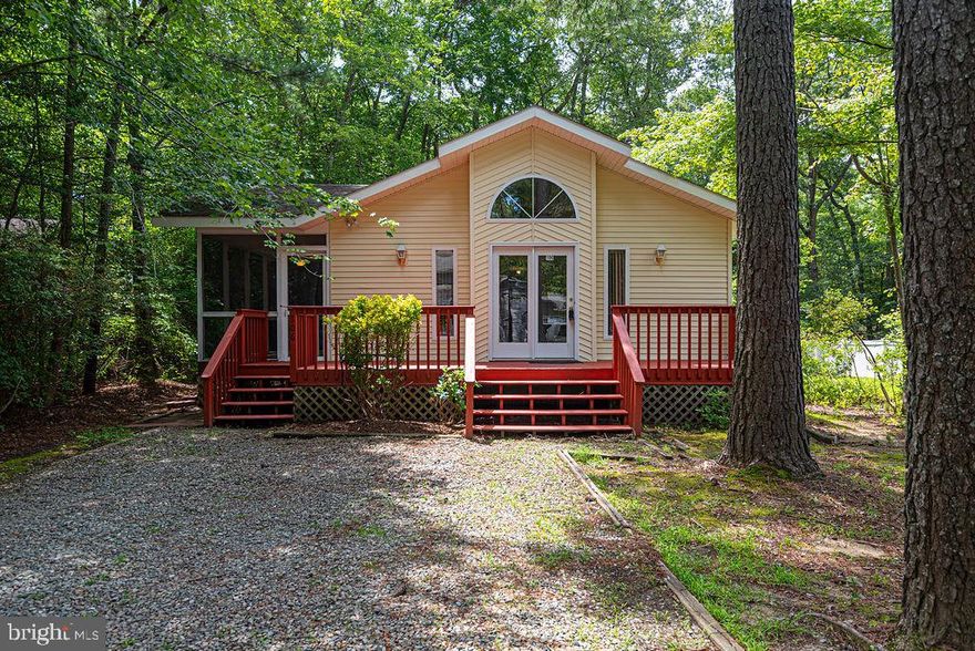 Cute-As-Can-Be One Level Home nestled among the trees in Sherwood Forest!  Brand New Carpeting, Freshly Painted, and Newly Encapsulated Crawl Space.  Vaulted Ceilings and sunny windows add appeal to the great room, which features a wood stove and brick hearth. The kitchen contains a breakfast bar, and access to the 16x8 screened porch.  Both bathrooms have tub/showers, and the Primary Bedroom has a walk-in closet.  A relaxing deck spans the front of the home.  Enjoy the Ocean Pines amenities and the easy access to Ocean City and Assateague Island's beaches!