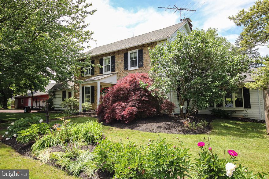 Take a step back in time at Hickory Dell Farm and soak in the beauty of timeless stone walls, exposed beams, warm hardwood flooring,  deep window sills, flagstone walkways, and the simple country life that makes this 1700’s farmhouse so special.  Be it your forever home or a weekend retreat,  this exceptional home situated on 13+ acres in Hilltown has been thoughtfully expanded to offer ample living space for modern lifestyles.  Stepping into this home you are all at once enchanted by the old world charm.  The focal point of the living room is the amazing wood-burning stone fireplace, and this room opens to a remarkable 27’ X12’ flex space.  This space could be used for all sorts of reasons--a music room, 2nd family room, a home office or dedicated home-schooling area.  Although considering this space an extension of the living room seems natural, the gorgeous French doors can close this bonus room and living room from the busy family room, making this a quiet work or study space. The dining room boasts an exposed stone wall, exposed beams and a corner built-in cabinet; the new homeowner will undoubtedly make many future holiday memories in this room.  Better seen in person is the remarkable wrap-around family room.  It boasts a corner stone fireplace with a Vermont Casting wood stove and a classic raised stone hearth, gorgeous hardwood flooring, and dramatic vaulted wood ceiling.  There are also many windows looking over the pastoral back fields, and expansive sliding glass doors opening to the composite side deck and sparkling in-ground pool.  Convenient to the family room, deck and pool is a wet bar, so this floorplan and pool location make it ideal for large group entertaining, both inside and out! A quaint country kitchen with exposed beams, vaulted ceiling, antique cross ladder and cozy wood-burning fireplace and a powder room with an exposed stone wall complete the main level.  The upper floor has four bedrooms, all with warm hardwood flooring, and a full bath with barnwood walls and a double vanity.  Stairs to the floored attic provide easy access with tons of storage space including the added bonus of a deep cedar closet!  The 3-bay expansive garage offers two rooms with private exterior doors that, with adjustment, would make either a great workshop, studio or office--one is 23'X12' and the other is  23'X15'  with kennel runs.  A large barn is behind the garage and although it is currently used for storage, it has five stalls which could be renovated for your barnyard pets!  These two outbuildings in combination with the  huge equipment shed make this property ideal for any car enthusiast or would make safe spots to store your kayaks, motorcycle, or boat –there are endless possibilities for all these outbuildings; please check with the township for allowable uses.  Tranquil views of open flat fields surround the home, and a large delightful pond can be found near the rear property line in front of a beautiful wooded area.  Special features include a NEW septic system, a small pavilion with stone barbeque grill, wood shed, and a newer electric panel, family room a/c unit, pool filter and pool cover.  Do you want to conveniently run/walk/bike the 6-mile loop around Lake Galena each day or is your passion to sail, boat or fish on the weekend? Then this is the house for you as Peace Valley Park is less than five minutes away! It’s also just a quick ride to historic Doylestown and an eight-minute drive to the Chalfont Train Station which makes a trip to Philadelphia easy.  The new homeowners will have the comfort of knowing America’s Preferred Home Warranty is included. All measurements and boundary lines are approximate. Pennridge Schools.  Act 319.