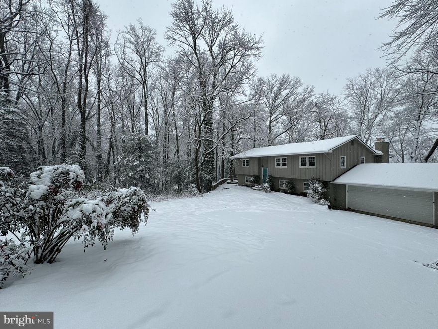 Welcome to this amazing waterfront oasis on over 5 acres of lush, private surroundings. This stunning home offers over 3,200 sq. ft. of living space, designed to embrace outdoor living and maximize the wonderful views of Church Creek. As you enter, you'll be greeted by an abundance of natural light and an open-concept layout that creates a seamless flow throughout the home. The spacious kitchen is perfect for entertaining, while the separate dining room sets the stage for memorable dinner parties. The main level family room features great water views, a cozy fireplace and provides a wonderful transition to the deck, offering an extension of living space for outdoor dining and relaxation. Downstairs, the versatile lower level boasts plenty of natural light, a large recreation room with built-in's, a second fireplace, three bedrooms, a full bath, laundry, and access to the garage. Step outside to the stone patio and enjoy the serene water views, brand new hot tub, and cozy evenings by a firepit. A private path leads to your pier, complete with water, electricity, and a jet ski lift, allowing you to fully enjoy Church Creek with your power or sailboat. For the outdoor enthusiast, grab your paddleboard and soak in the beautiful scenery. Additionally, a separate structure on the property offers a great opportunity for a home office, studio, or gym. This location offers the best of both worlds - just minutes from Eastport and downtown Annapolis, with easy access to commuter routes, yet providing a peaceful retreat amidst nature with approximately 250’ of waterfront. Experience the waterfront lifestyle just off the South River and close to the Chesapeake Bay. This property is truly a gem waiting to be discovered.