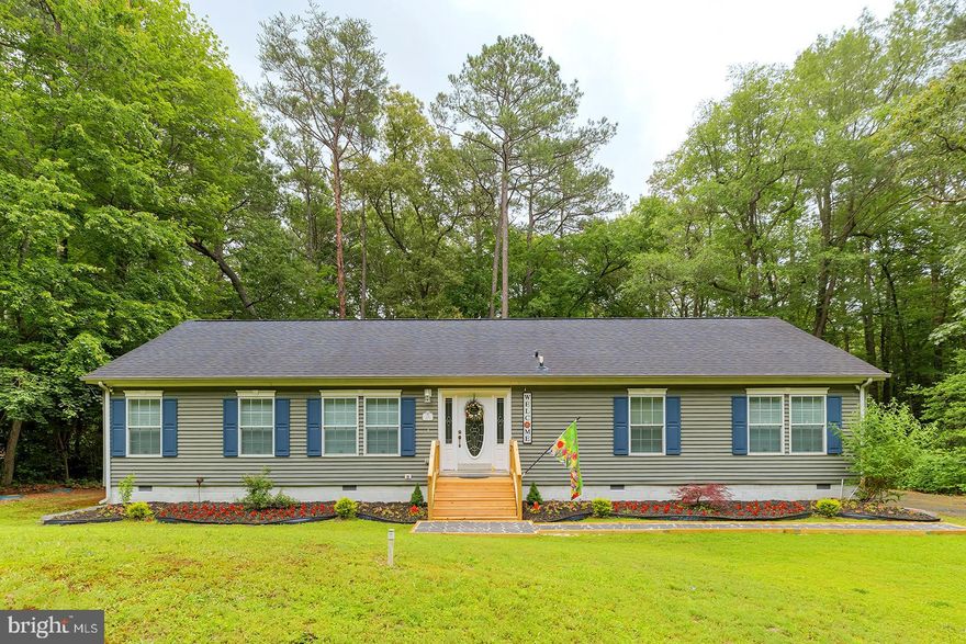 Welcome to this beautifully maintained 4-bedroom, 2-bathroom home nestled in the desirable Cave Colony area of Milton, Delaware. Spanning 2,640 square feet, this spacious residence sits on a partially wooded 0.71 -offering added privacy and a serene natural setting.

Step inside to discover an immaculate interior featuring luxury vinyl plank flooring throughout the main living areas. The inviting living room boasts a cozy fireplace, custom built-ins, a lighted ceiling fan, and a sliding glass door that opens to the deck—perfect for indoor-outdoor living and entertaining. The adjacent dining area is accented by a stylish chandelier, ideal for formal or casual meals.

The well-appointed kitchen is a chef’s delight with a central island, abundant counter and cabinet space, and sleek stainless steel appliances. The four bedrooms are comfortably carpeted, providing a soft, quiet retreat. The spacious primary suite features a ceiling fan, a luxurious ensuite bathroom with a soaking tub, step-in shower, and double vanity sinks. A generous walk-in closet is conveniently located adjacent to the bathroom.

Additional highlights include a dedicated laundry room located next to the back entrance and a private outdoor shower—great for beach days or gardening. Enjoy peaceful mornings or evening gatherings on the deck while taking in the natural beauty surrounding your home.

Don't miss the opportunity to own this stunning, move-in-ready home in one of Milton’s most charming neighborhoods.