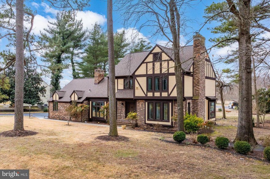 Brimming with updates, this 3875 sq. ft., 4 bedroom, 3.5 bath Nithsdale residence offers a host of inviting spaces for living and entertaining.  While the exterior is a charming Tudor design, the interior is best described as bright and modern. Features include luxury vinyl plank 'wood' and tile flooring throughout the main areas of the 1st floor, a dramatic 2-story foyer with cascading crystal chandelier and an open staircase enhanced by a contemporary metal handrail, three 1st floor fireplaces w/ stone facings, an updated powder room, an updated eat-in kitchen w/ center island and stainless appliances, a stunning family room with soaring 10 ft ceiling, a wall of windows and full view glass doors, as well as ample built-in storage cabinets, a window-filled living room w/ French door entrance, a spacious dining room, 2 rooms that can serve as home offices, and a laundry room w/ washer, dryer, utility sink, and garage access. The 2nd floor offers a primary bedroom with gas fireplace and updated bathroom complete w/ dual sink vanity, soaking tub and walk-in shower, a 2nd bedroom w/ private bath, 2 additional bedrooms, a full hall bath, and a spacious bonus room outfitted as a walk-in closet that any clothes lover would appreciate! The home's exterior provides an inviting patio with overhang  and additional patio space with a pergola to enjoy the warm weather months ahead. Includes a one-year AHS 'Shield Complete' Warranty ($840)