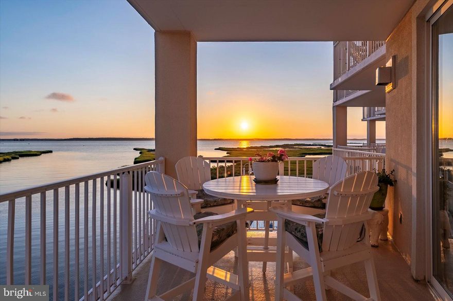 Stunning Bayfront 3BR/2BA Condo with bayfront pool!  Don’t miss this rare opportunity to own a spacious and beautifully maintained 3-bedroom, 2-bath condo overlooking the tranquil bay. Perfect as a year-round residence or a serene second home, this condo offers spectacular sunset views and a front-row seat to coastal wildlife—every evening feels like a retreat. Step inside to find soaring 9-foot ceilings and an abundance of natural light throughout. The gourmet kitchen features a convenient breakfast bar, and plenty of cabinet space for all your culinary needs. Just off the kitchen is a dining area ideal for gathering with family and friends, which flows seamlessly into the cozy family room complete with a fireplace—perfect for cool fall and winter nights. Glass sliders in both the family room and primary bedroom lead to an oversized deck with panoramic water views, making indoor-outdoor living effortless. The spacious primary suite includes a walk-in closet and a spa-like en suite bath with a Jacuzzi tub and separate shower. Two additional bedrooms and a full guest bath provide comfortable accommodations for  all your guests. A full-size laundry room with offers added storage space, while a ground-level storage unit is perfect for beach gear and toys. Relax by the pool with stunning bay views and refreshing coastal breezes. Unwind in comfort as you soak up the sun or enjoy a peaceful sunset. The condo complex also features a convenient ground-level grill area—perfect for hosting a barbecue with family and friends. There’s even a kayak rack for your waterfront adventures! Relax and take all the sights and sounds in front of the pond. This well-maintained building includes covered parking, a secure lobby, and an elevator for your convenience. Located just a few blocks from the beach, and close to shopping, dining, and entertainment, this home combines the best of bayfront tranquility with easy access to all the action. Sold fully furnished, this condo shows true pride of ownership. Don’t miss your chance to enjoy the coastal lifestyle you’ve always dreamed of owning!