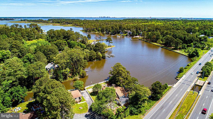 Price Improvement! Motivated Seller-willing to negotiate seller concessions-Bring your Best Offer!
Seize your opportunity to enjoy coastal living along the tranquil waters of Herring Creek, in West Ocean City, MD. Beautifully situated on 0.7 acres with more than 445 feet of water frontage, your own private boat ramp for watersports, kayaking or paddleboarding, a dock for fishing and crabbing, and one of Maryland’s few remaining original Boathouses, 12217 Ocean Gateway offers a harmonious blend of coastal serenity and everyday convenience! This iconic farmhouse is rich in history and exudes warmth and character at every turn. The newly renovated heart of the home showcases a farmhouse kitchen filled with natural elegance including a wood-burning fireplace, gathering island, over-sized dining space and panoramic water views where you can enjoy your mornings on the inviting screened veranda. With elevated finishes, gorgeous tilework, natural tone flooring, newly installed cabinets and countertops, and brand new appliances (2025) this space will be perfect for entertaining. Water views from every room make it difficult to choose where to take in the scenery.  With the main level  canvased in new, modern honey-toned flooring- stepping in the charming entryway you may choose to relax in the sun-drenched sitting room or continue straight where you are drawn to the window-lined main living space including a cozy fireplace- take in all that Herring Creek has to offer with a front row seat to the captivating marine life including turtles, heron, bald eagles and even otters. Continue into a quaint conversation nook perfect for reading then into the optional mudroom with adjacent laundry space with access to the sprawling backyard with endless possibilities. Your new home features a first floor en-suite with updated bath and sparkling water views, a second story owner’s retreat complete with a walk-out balcony overlooking the creek, cathedral ceilings, a cozy sitting space, walk-in closets and of course a freshly renovated spa bath with stylish finishes and soaking tub. The second floor also features a second elegantly updated full bath as well as three additional designated bedrooms or optional flex spaces with brand new carpeting. While this home lives like a five bedroom the on-site septic system is permitted for 3 bedrooms. 
As if the main residence is not enough, you will find an adjacent versatile 1,500-square-foot office building with its own bathroom and ample storage and an HVAC replaced in 2021. With many possibilities this unique commercial zoned space may be permitted as an office, gym, studio or workshop with plenty of parking to meet the needs of your entrepreneurial endeavors! If business is not for you this office unit can be leased with proper zoning permits.  All options for use of the commercial space, including permits, are to be confirmed with the county by the buyer.

Located just minutes from the vibrant Ocean City Boardwalk, known for its historic charm and lively attractions, and the pristine beaches of Assateague Island, this property offers the perfect balance of peaceful retreat and coastal adventure. Whether you're seeking a personal residence or a unique business or investment opportunity (as this home is outside the city limits encumbered by vacation rental restrictions), 12217 Ocean Gateway stands as a rare gem in the heart of Maryland's Eastern Shore- call it HOME today!