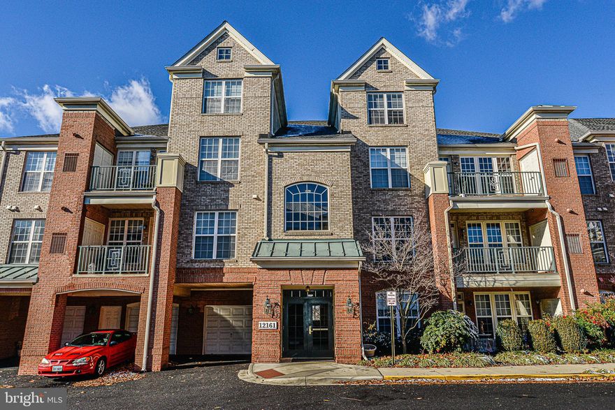 This is a must-see!  Model Like!  Reston Town Center! 2 Bedroom, 2 Bath Condo unit with Den.    Beautiful Kitchen with Corian counters and Updated Stainless Steel Appliances. Delightful Living Room with fireplace. Dining Area.  Hardwood floors, crown molding, chair rail and lots of natural light. Generous Master. Private Bath with soaking tub, separate shower and dual sinks. Incredible View! Enjoy all that Reston has to offer. Convenient to shops, restaurants, METRO, Dulles Airport and major roads. 2 parking passes - 1 reserved space.