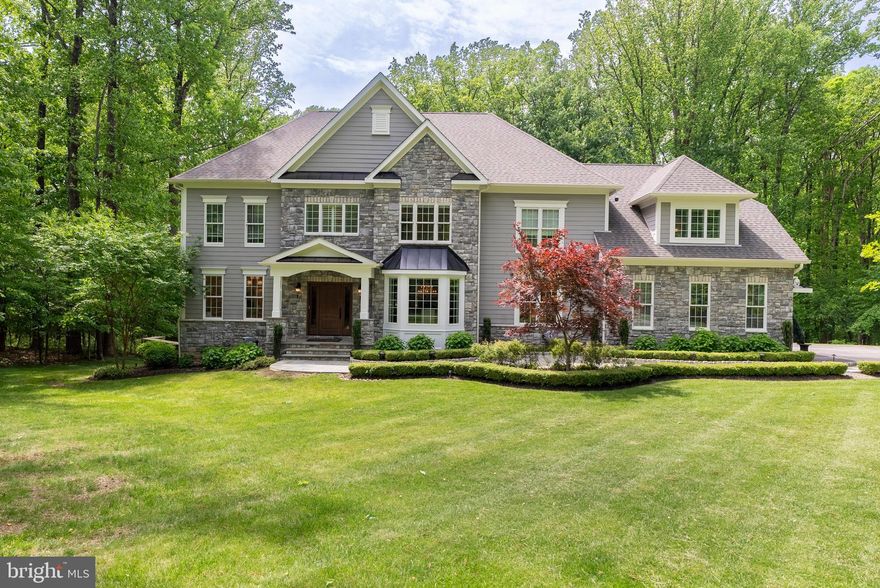 Falls Road Corridor. Prime location. Beautiful 5 bedroom 5 full baths and a half bath on the first floor,  stone and hardy-plank Colonial on 1.98 gorgeous acres.  Grand foyer  with  hardwood flooring and curved staircase.  Family room offers wood flooring , stone wood burning fireplace with beautiful built-ins for entertainment center and wine display with wine cooler.  The Formal dining room is awesome-wood floors as well as beautiful bay window and decorative molding. The beautiful white kitchen with huge 11.5 by 3.5 granite island with prep sink and pendant lighting also offers gas cooking with pot filler over the stove so convenient- farm sink, granite counter tops throughout, hardwood flooring and a tremendous amount of cabinets even in the island with a beverage fridge. Large walk in pantry with built in nugget icemaker, up lit Quartzite counter, and organized shelving.  The guest bath has a pedestal sink and also wood flooring.  First floor laundry/mud room with cubbies just off of the oversized three car garage.  There are three garage door openers, it's heated and newly installed garage tech cabinets. Also on the first floor is a beautiful office with gorgeous built-in desk that has quartzite counter top with shelving, wood floors and decorator window treatments.  Need space for or in-law or guests there is a first floor bedroom with ensuite full bath.   Off of the kitchen  is terrific outdoor living and entertaining. The treks decking with white railings that have cap and down lighting all around offers a covered area that has two tv's, two fans,  heaters and ambient lighting, plus a built in large gas grill that conveys.  When you go down the steps to the beautiful level yard there is a wonderful very kid friendly Amish play set that the children will love.  Plenty of room for soccer, softball, lacrosse practice.  Now upstairs there is an absolutely gorgeous primary suite consisting of a very large primary bath with tile shower with multiple shower heads, a bench and glass surround- there are two sinks on either side of the bathroom with granite counter tops and built-in cabinetry, separated by a bench for storage- There is a soaking tub and plenty of built-ins.  There is even a private beverage area with sink, cabinets and beverage fridge. The water closet has a frosted glass door.  There are three other bedrooms two are connected by an adjoining complete full bath  with a double vanity with granite counter top, and a fourth bedroom has it's own private ensuite bath- You will also find a huge family room  with a walk in closet.  All of the closets are designed by California Closets for maximum storage.  Now for the lower level. First of all it is a walk out lower level to the back yard-there is an exercise room with rubber flooring-and there is plenty of space for entertaining.   The full bath on this level is extraordinary.  The beautiful lighted vanity with marble counter has  pendant lighting, the gorgeous 3 headed tile shower with a Kohler digital shower interface with glass door are only the beginning of what this bath has to offer.  The large utility room houses a utility tub, the holding tank for the whole house sprinkler system, a Novine on demand tankless water heater, purification water system, whole house water booster for great pressure throughout.  Plus a Moen digital water flow smart water shut off that detects water leaks immediately.   Also this home offers a whole house 20K Kohler generator. Other amenities- alarm system, crown molding, self closing drawers and cabinets,  room for a pool and just a beautiful location.