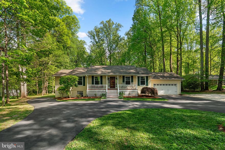 Situated in the highly sought-after community of Highland, this beautifully renovated rancher offers a perfect blend of modern upgrades and serene outdoor living. This home sits on a prime wooded lot backing to trees and is zoned for the premier River Hill school district. Major exterior updates include a new roof with architectural shingles (2019), new vinyl siding (2012), energy-efficient windows (2009), new septic tank (2012), an easy-care composite deck (2012), and a two-zone HVAC system (2012/2017) with UV air filtration.

The heart of the home is the stunning 800 sq. ft. addition completed in 2012, which flows seamlessly with the original layout. Inside, rich Brazilian Koa hardwoods span both the main and lower levels. The renovated eat-in kitchen is a chef's delight, featuring refaced cabinets, granite countertops, a tile backsplash, upgraded stainless steel appliances, and a breakfast bar with pendant lighting.

The main level hosts three spacious bedrooms and two full bathrooms, including a primary suite designed for relaxation. The primary bedroom features a sitting room with cathedral ceilings, a slider to the rear deck, and double walk-in closets. Its renovated ensuite bathroom is equipped with a double-sink vanity, a glass walk-in shower, extensive tile work, and heated floors. Throughout the home, crown molding and an extensive recessed lighting package add a touch of sophistication.

The finished walk-out lower level serves as a versatile living space, featuring an expansive recreation room with a propane fireplace and dual sliders (2015) that lead to the rear paver patio with low-voltage lighting. This level also includes two additional bedrooms with walk-in closets, a third full bathroom, a laundry closet, and a dedicated storage/utility room.

Outdoor amenities include a welcoming front porch, a two-car garage with a workspace, a massive walk-in shed and NO HOA fees (shared driveway fee of approx. $200/yr applies). This is an immaculate home and a must see!