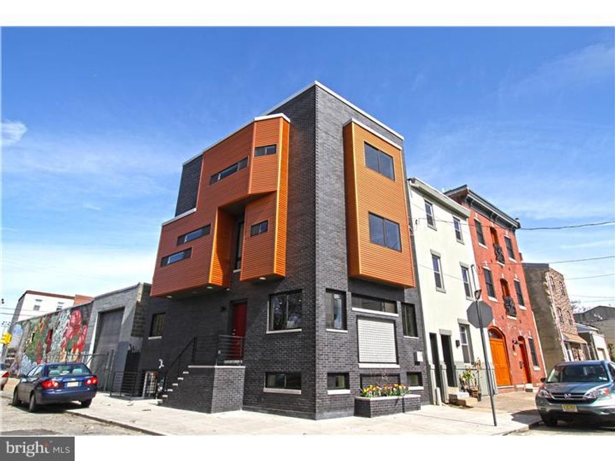 Enjoy this luxury 4 story corner New Construction w/ 10 Year Tax Abatement that offers 3 large bedrooms, 2.5 baths, hardwood & recessed lighting  throughout, multiple outdoor spaces including a roof deck w/ panoramic views & a finished basement built partially above ground level. Curb appeal is vibrant w/ texture including a built-in flower box for plantings plus a "green wall" trellis perfect for flowering vines. Currently we have planted flowering honeysuckle! We love the wide floor plan & over 2,500 sprawling sq ft. of living space. The rare opportunity to be on a corner allows natural light from 3 sides. The 1st floor is raised above street level offering maximum privacy. This main level is expansive w/ an open living room, dining room & kitchen. There is a convenient coat closet & powder room w/ pocket doors tucked away. The kitchen is fitted w/ quartz counter-tops, a waterfall quarts Island w/ under-mount sink, goose neck faucet, dishwasher & ample seating at the bar. The 42" Shaker style cabinetry is perfectly paired w/ a stunning white subway tile back splash, high-end stainless appliances, gas range w/ vent hood, & a lower microwave cabinet. The refrigerator includes a water feature, pull out freezer drawer & French doors. All stairs have custom iron forged railings including those that lead to the finished basement. The basement is partially above terrain giving an above ground feel & more natural light. Floors are beautiful contemporary polished concrete. 2nd floor level has 2 big bedrooms w/ 2 panel wooden doors & custom windows maximizing every view. Guest bedrooms share a hall bath w/ floating vanity,  a soaking tub & shower combination, & custom tile work. There is a laundry closet in the 2nd floor hall as well. The master bedroom 3rd floor is stunning w/ a bonus "flex space" / "nook" that can be a sitting area, a place to feature a beautiful vintage piece of furniture, or whatever your heart desires. The huge closet can be accessed through the en-suite bath or through the bedroom. The master bath has a glass enclosed shower, dual sink, storage vanity  & custom tile. The 3rd floor hall staircase leads to a roof deck pilot house. The roof deck has panoramic views of Philadelphia & Center City. We must mention that this home is extremely air tight due to the use of spray foam insulation throughout which equates to low utility bills for you. An extremely friendly walkable location in Fishtown close to great cafes & restaurants!