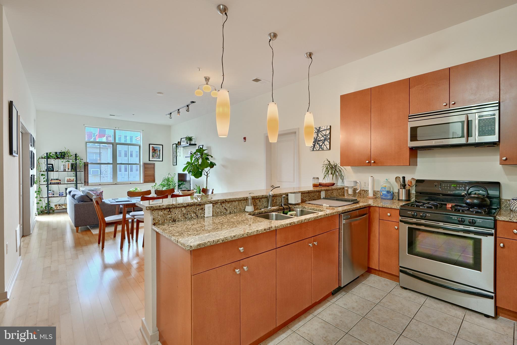 Welcome to unit 303 in Twelve09 North Charles, a bright and sunny and well-maintained 2bd/2ba condo in the heart of Mount Vernon! Featuring spacious rooms, hardwood floors, large windows and a private balcony. The open floorplan is perfect for entertaining guests and offers enough room for a dedicated dining area, living room and bar area. The kitchen is well equipped and includes large cabinets, stainless steel appliances and granite counter tops. There's a full guest bathroom with tub/shower combo, plus access to the private guest bedroom. The primary suite offers a walk-in closet, large footprint, ensuite bathroom with double vanity and large shower and ample storage space. Stop in today and prepare to be impressed with this incredible value in Mount Vernon!