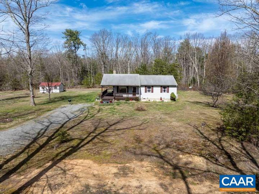 Discover the charm of a 3-bedroom, one-level home on 3 acres in scenic Madison County, just a 10-minute drive from Rt 29. This property boasts a 240 sq ft metal garage on a concrete slab with electric & a generator hookup, along with a spacious shed with electric for tools, lawnmower & garden storage. The land encompasses approximately 1.5 acres of open yard & 1.5 acres of wooded terrain, providing a perfect balance. The level lot features a large sunny garden area & ample parking space. Enjoy the recently stained covered front porch that wraps from the side door to the front door. Inside, the eat-in kitchen showcases freshly painted cabinetry & space for a kitchen table, seamlessly flowing into the living room with a large picture window, wood stove flue, & a convenient coat closet. The pantry is just around the corner from the kitchen. Down the hall, two bedrooms with closets & ceiling fans await. The full bathroom offers a tub/shower, commode, single vanity & laundry in the closet. A half bathroom, adjacent to the full bathroom, leads to the primary bedroom. The home features durable Hardie plank siding, and recent updates include a well pump in 2021 & a pressure tank in 2019.,Formica Counter,Painted Cabinets,Wood Cabinets,Fireplace in Living Room