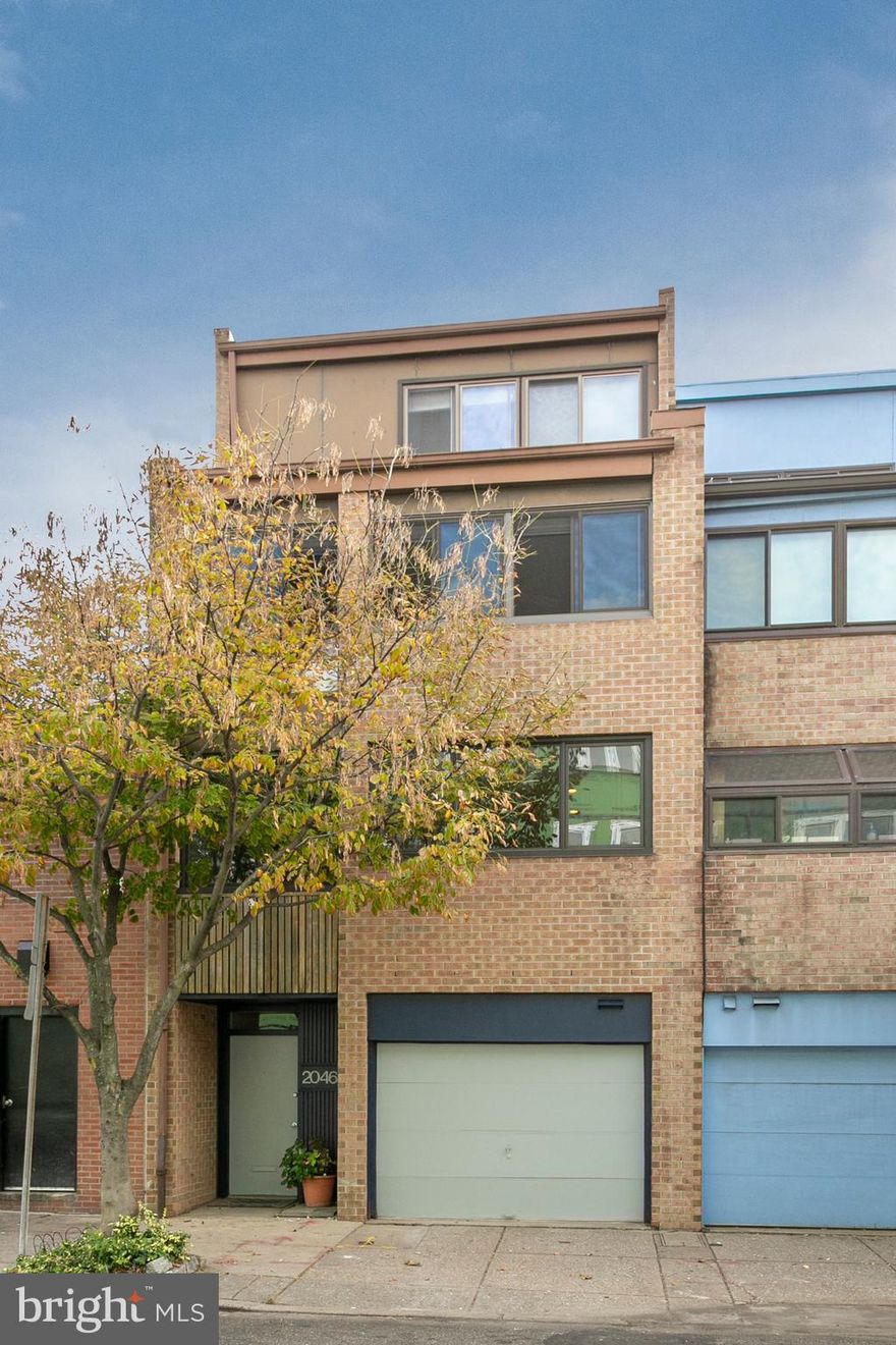 This attractive 4 bed, 3.5 bath, 19-foot-wide split-level home with garage parking is looking for its next owner!  Expansive landscaped garden, incredible amounts of glass and natural light, and open staircases make this home absolutely stunning. Add to that, dual views, front to back, city or garden!The entry level features an extra-wide garage and coat closet.  A few steps down leads into the home office with built in shelves, a walk-in storage closet, half bath, and tile floor.  A glass door leads out onto the beautifully landscaped garden that includes a large deck, brick privacy wall and professional landscaping with full grown trees - the ultimate oasis in center city.  The owners love sitting in the garden for their morning coffee and their evening nightcap.  The backyard is ideal for escape and entertainment. This home has the space both inside and out to host an intimate dinner or a celebration for 50 people comfortably!  It is a hidden gem!From the entrance, step up into the dramatic two-story living space offering soaring ceilings, a fireplace, and floor to ceiling windows overlooking the tranquil backyard with access to the outdoor space.  A few more steps take you to the oversized updated kitchen with KraftMaid wood cabinetry, Silestone counters, stainless steel appliances, built in china cabinet and a large island that allows for cooking and conversations.  Enjoy meals in the adjacent dining area overlooking the living room or cozy up with a good book in the corner banquette with hidden storage beneath.  As you continue to the next floor, you will find your master bedroom suite with walk-in closet and updated master bath with double sinks.  A second en suite bedroom with updated tiled bath, linen closet, and laundry room are conveniently located on the same floor.The top floor to this magnificent home offers two additional large bedrooms and a renovated hall bath lit by clerestory windows.  The rear bedroom with built in closets faces the lush garden and the front bedroom has skyline views.  An added bonus is a skylight on this floor that streams natural light throughout the home.This home has been loved and appreciated by the current owners who have found the location convenient to so much the city has to offer.  Enjoy the proximity to Lombard Swim Club, Schuylkill River Trail, Dog Walks, Taney/Markward playground, Fitler Square, Honey's, Ten Stone, City Fitness, 20th street restaurants, cafes, and all of the boutiques, restaurants and nightlife in Rittenhouse Square and more. Easy access to Penn and 30th street station. Greenfield School Catchment.  Enjoy this home as the Sellers have and make the next memory at 2046 Lombard your own!  Check OPA for 2020 taxes