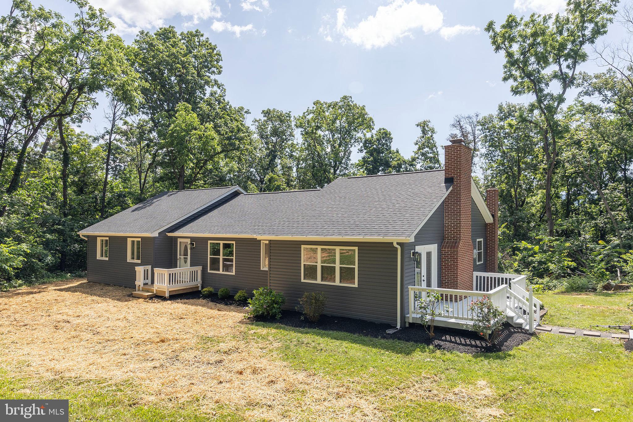 Fully renovated in 2025, this 3-bedroom, 2.5-bath ranch is situated on a peaceful 3-acre partially wooded lot with fresh landscaping and thoughtful updates throughout. Inside, you'll find brand-new bathrooms complete with updated lighting, vanities, toilets, faucets, tubs, and showers. The home features new vinyl plank and ceramic tile flooring, a completely redesigned kitchen with new cabinets, granite countertops, a center island, and modern lighting. The entire interior has been freshly painted in a neutral palette. 2025 Exterior improvements include new siding, a new roof (30yr Architectural Shingles), some new replacement windows (Double Hung-Vinyl), and new decking and rails on both the front and rear porches—perfect for relaxing and enjoying the natural surroundings. 2025 a new septic system installed, and the property also includes a water system with UV light, conveyed as-is. Shed conveys as-is. Fireplace conveys as-is and second chimney is sealed off and conveys as-is. *Agent is related to owner* The information contained herein is for informational purposes only. RE/MAX Roots makes no representation as to the accuracy or reliability of the information. The buyer is to verify information provided and related to the property that is material to a buyer’s decision to purchase the property. All documents and other information attached to this listing are provided as a courtesy and should be researched and verified by the buyer agent.