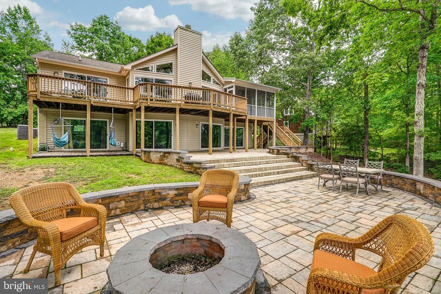 Escape to your beautiful, fully furnished waterfront retreat situated along the peaceful shores of Lake Anna on the public side of the lake. Located on a 1 acre cul-de-sac lot in the very sought after Wyndemere subdivision at prime mid-lake location with gorgeous views & deep water. Comcast Xfinity internet is available here! Relax in over 3,400+ finished square feet featuring 5 BDRMS, 3 BTHS (3 bedroom septic), an open floor plan and a split bedroom design. Family room with vaulted ceilings, wood beam accents, a stone wood burning fireplace and sliding doors to the expansive deck. Spacious kitchen features maple cabinets and stainless appliances. Main level ensuite has a walk in closet and tile shower. Two other bedrooms and a full bath complete the main level. Finished walkout basement has a family room, rec room, two lakeside bedrooms, full bath and storage room. Whole house water filtration system. Beautiful views and 240 ft of prime rip-rapped waterfront. Covered boathouse with maintenance free decking, electric boat lift, storage room and sun deck (deep water, 12-14 ft at end of dock). This lake oasis is perfect for entertaining or for any family to enjoy. Screened in porch, concrete patio, extensive hardscaping, outdoor shower, fire pit, oversized 1 car garage & a paved circular driveway. At this retreat you can truly relax and let your stress drift away. Come see for yourself, fall in love and explore everything that beautiful Lake Anna has to offer. Wyndemere is a golf cart friendly community and offers three common areas, a boat ramp, tennis and basketball courts. Easy water access to restaurants and marinas and is conveniently located to the Lake Anna Food Lion, ABC, nail salon, restaurants, tap house, winery, cidery, brewery, Yacht club, state park, MooThru ice cream and mini golf! **water heater 2020, patio & fire pit added 5 years ago, stainless appliances 2018, driveway paved 2020**