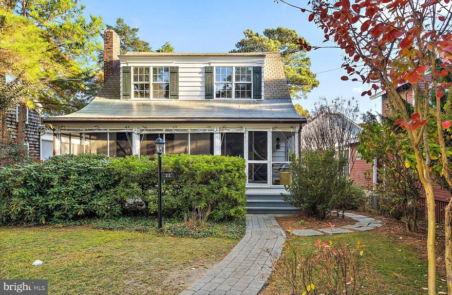 Welcome to 22 Park Avenue, an enchanting "Old Rehoboth" ocean block cottage nestled in the exclusive Pines neighborhood of Rehoboth Beach—an ideal seaside retreat brimming with historic charm and modern conveniences. This delightful property sits on a 50' x 100' parcel, surrounded by mature trees that provide both privacy and tranquility, just steps from the ocean. The heart of this charming home is the spacious screened porch, where you can relax and savor gentle ocean breezes and the soothing sound of waves crashing nearby. Inside, the home exudes coastal elegance with its beamed ceilings, rich hardwood floors, and a wood-burning fireplace – capturing the essence of classic Rehoboth charm. Tasteful renovations bring functionality and convenience to the home, offering everything you need to enjoy easy coastal living. The main house features four spacious bedrooms and two full baths, while the guest cottage provides an additional bedroom and bath, sitting room, and private patio, making this property as versatile as it is charming. With a strong rental history, 22 Park Avenue offers investment potential and an idyllic summer getaway for those seeking the quintessential beach lifestyle. This rare gem combines the historic allure with modern amenities and offers the best of Rehoboth Beach just outside your door. Don’t miss your chance to own a piece of paradise!