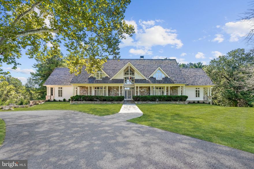 A stone and plank exterior show off this exceptionally built transitional floor plan situated on a 10.5 acres magnificently manicured lot in one of Howard County’s most elegant subdivisions. The 9564 finished square feet on three levels provide a variety of lifestyle possibilities that all occupants will enjoy. A circular drive surrounding a pair of 200 year old trees welcomes everyone to the property. The main house features a first floor with three distinct living areas. The living and family rooms are separated by a large dual sided stone profile fireplace, one of three in the home. A fully finished sunroom adds more magnificent main level space. The first and second level flooring is complemented entirely with Brazilian cherry hardwood except for the kitchen which has an "easy on the feet" cork floor. The library features floor to ceiling wall to wall bookshelves. A large formal dining room for the special occasions backs to the open concept kitchen and breakfast area. A Viking gas (propane) range and stainless steel appliances including an Electrolux refrigerator and separate freezer are surrounded by a myriad of storage space cabinetry. A glass elevator services all three floors. The first of two primary bedroom suites adjoins the kitchen and features two large walk in closets plus an inviting balcony that overlooks the property. The second floor has four generous sized bedrooms including a second primary bedroom with its own stone fireplace. All adorned with en suite baths. A 42x32 recreation room with the third stone fireplace highlights the lower level boasting newly installed plush carpeting, which also has a large multi-purpose room with an adjacent full bath plus a separate 26x24 exercise room. An 80x67 two story wood beamed natatorium houses a 60x30 saltwater indoor pool (no chlorine smells) with extensive flagstone decking and a six person hot tub. A 200 plus year old stone barn has been refurbished into a great entertainment area and it includes a full kitchenette plus a full and half bath and usable loft area and a 15 foot drop down projection movie/tv screen. The barn has indoor parking for three cars as does the main house. This is truly a masterpiece one of a kind home!