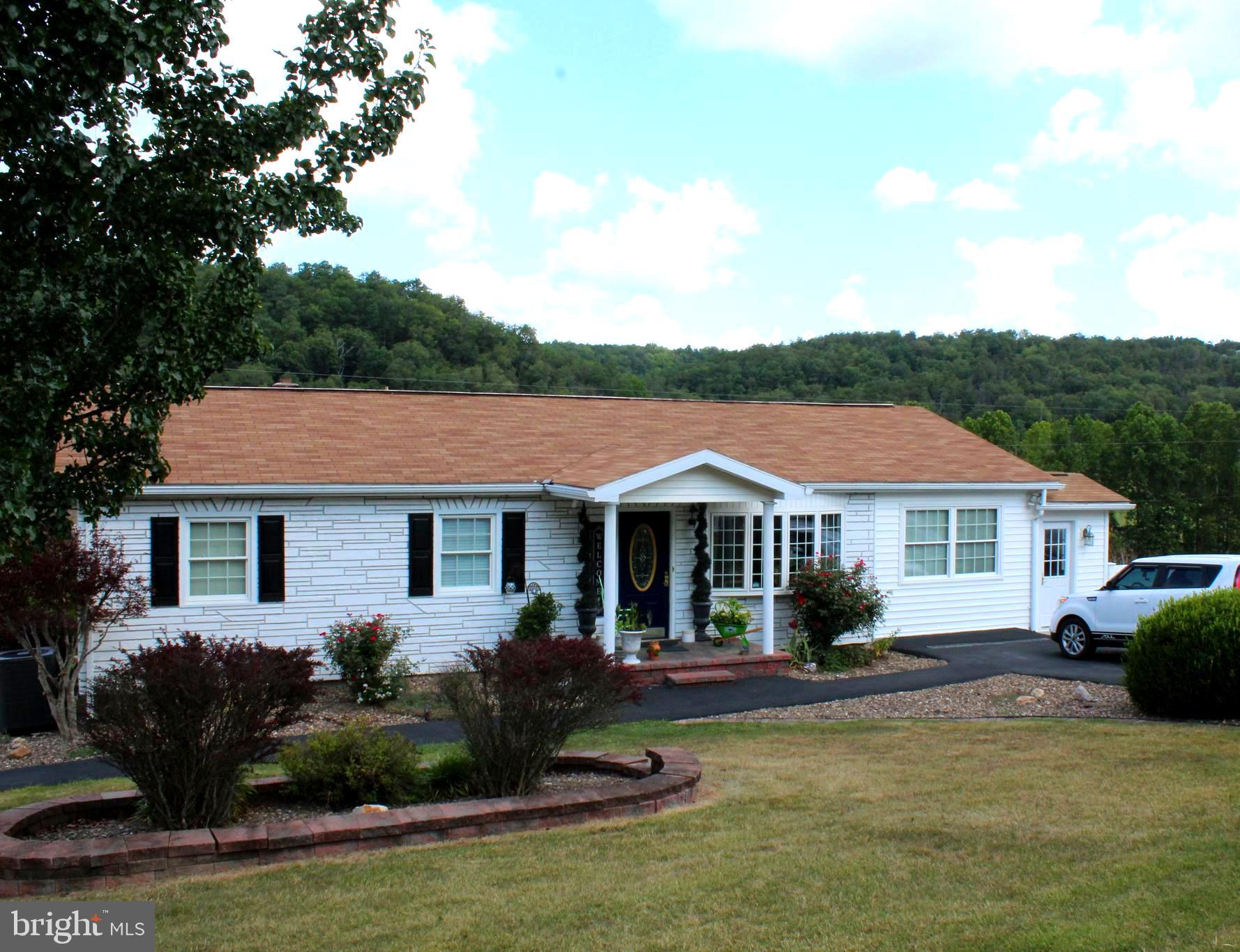 Country Living at it's finest! Mountain & pastoral views all around. This rancher has had many updates including maple cabinetry and stainless appliances in the kitchen. Spacious living and dining area with an open flowing floor plan. Need an extra bedroom, turn the current office/lounge area into the second main floor bedroom. Be sure to check out the nice touch of the quarter moon windows in this room. Fully finished basement is currently used as a salon Don't need space for a in home business, this space can be easily repurposed to a third bedroom and family/game room area. This level has a bath and spacious laundry room, also. Large decks off both the main and lower levels for relaxing in the countryside. Or sit and sip in the cobble stone area with the fish pond which is situated behind a white privacy fence. Detached 2 car garage with garage openers and a shed for all your outdoor equipment and toys. Only 4 miles from all the conveniences of shopping, banking & restaurants, Be sure to check it out today.