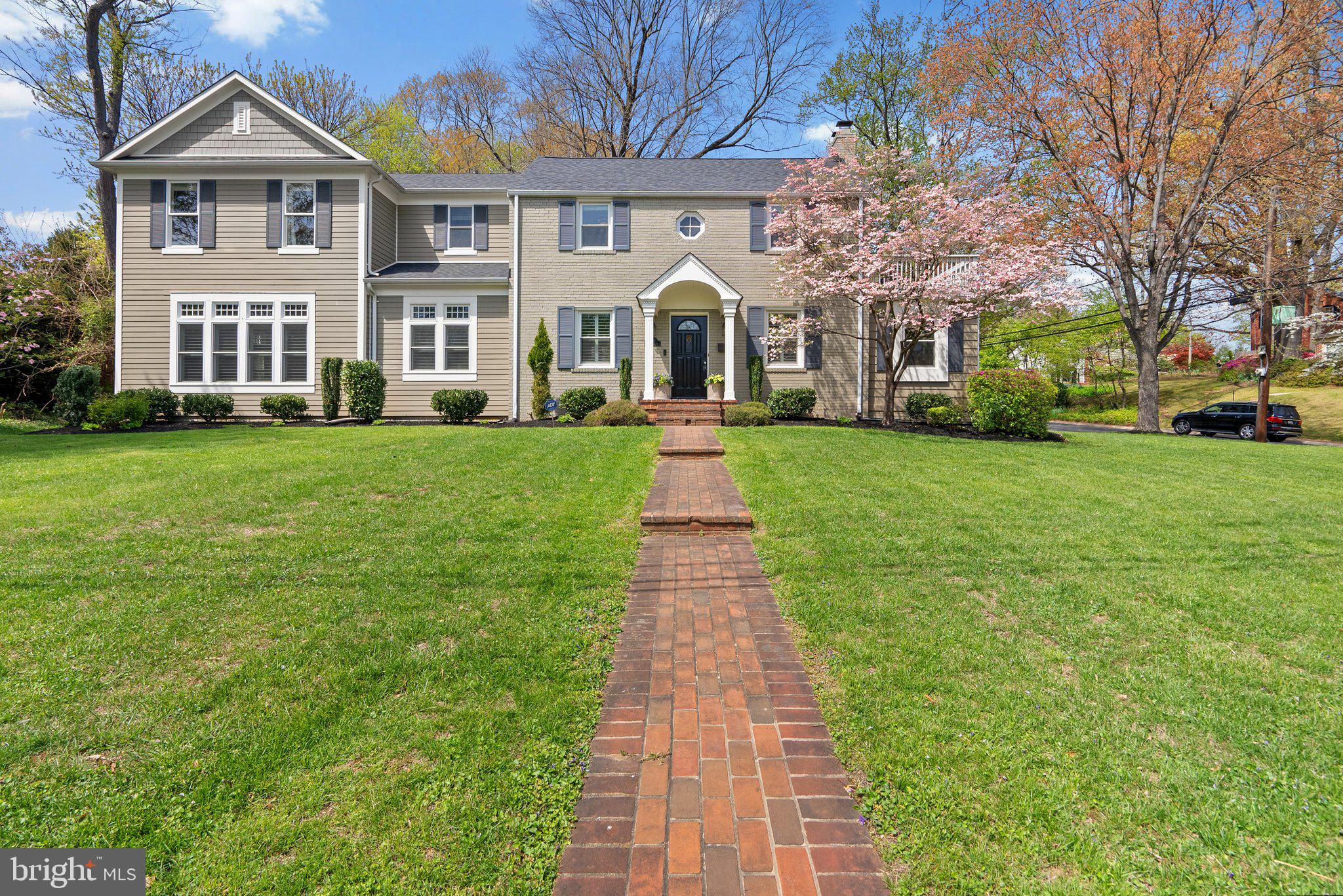 Welcome to 221 Williamsburg Drive—an architect-designed and thoughtfully expanded colonial-style home offering over 3,400 square feet of beautifully finished space, situated on a rare double lot on one of Woodmoor’s most picturesque, cherry tree lined streets. Step through the front door into the formal living room, where crown molding and a wood-burning fireplace create an elegant and inviting space. Just off the living room is a charming library/den with views of the side yard. .The dining room features timeless wainscoting & recessed lighting, offering a warm and polished setting for hosting.Flowing from the dining room is the heart of the home—an open-concept kitchen and family room with soaring 10-foot ceilings and walls of windows that fill the space with natural light. The chef’s kitchen includes marble countertops, white wood cabinetry, top-of-the-line stainless steel appliances, and a full butler’s pantry wall. The kitchen opens seamlessly to the family room, where an antique mantel and gas fireplace anchor the space, and oversized windows overlook the grassy front yard.Also on the main level: a convenient mudroom and powder room. Upstairs, you’ll find four generously sized bedrooms, two full bathrooms, and a convenient laundry room. The primary suite offers a serene retreat with a spacious walk-in closet and a beautifully appointed en-suite bathroom featuring double sinks and elegant finishesThe fully finished lower level adds even more versatility with a second family room, a full bathroom, and direct access to the backyard—a perfect space for guests, hobbies, or play.
Living in Woodmoor means more than just owning a beautiful home—it means being part of a vibrant community. The Woodmoor Citizens Association hosts holiday celebration such as the Christmas tree and menorah lighting ceremony, 4th of July parade, Oktoberfest and the beloved Woodmoorstock music festival. Plus, you’re just a short walk to Woodmoor Shopping Center, public transportation, and all the conveniences you need.