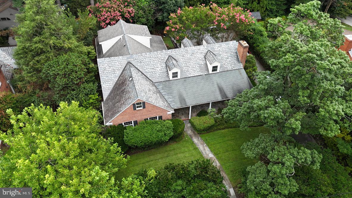 Privately tucked behind landscaped grounds, this beautifully updated and impressively sized five-bedroom, seven total bath Cape Cod blends timeless architecture with an unbeatable location. Located just minutes from top schools, including Boys Latin, Gilman, Bryn Mawr, Roland Park Country, and Roland Park Elementary/Middle, plus parks, shops, and dining, it offers both privacy and accessibility.
Inside, freshly painted walls and abundant natural light create a bright, welcoming atmosphere. The foyer opens to a spacious living room with a wood-burning fireplace and a formal dining room ideal for entertaining. A warm, wood-paneled library offers the perfect space for reading, working from home, or relaxing.
Two main-level bedrooms, each with a refreshed private bath, provide flexibility for guests or the option of a first-floor primary suite. The updated kitchen, complete with brand-new stainless steel appliances, flows seamlessly into a stunning addition featuring custom built-ins, wood flooring, a bar area, and its own full bath. This versatile space is ideal as a family room, entertainment hub, or private in-law suite.
From the addition, French doors open to a serene rear patio, offering the perfect setting for morning coffee, outdoor dining, or evening gatherings. Upstairs, three spacious bedrooms and two full baths provide plenty of room for family or guests.
The fully finished basement offers a large recreation area with a built-in bar, while an unfinished section provides generous storage. Recent upgrades include a new HVAC system, new water heater, refreshed bathrooms, and more, giving you peace of mind for years to come.
With its flexible large layout, classic charm, and thoughtful updates, this Roland Park home delivers the perfect balance of character and modern living in one of Baltimore’s most sought-after neighborhoods!