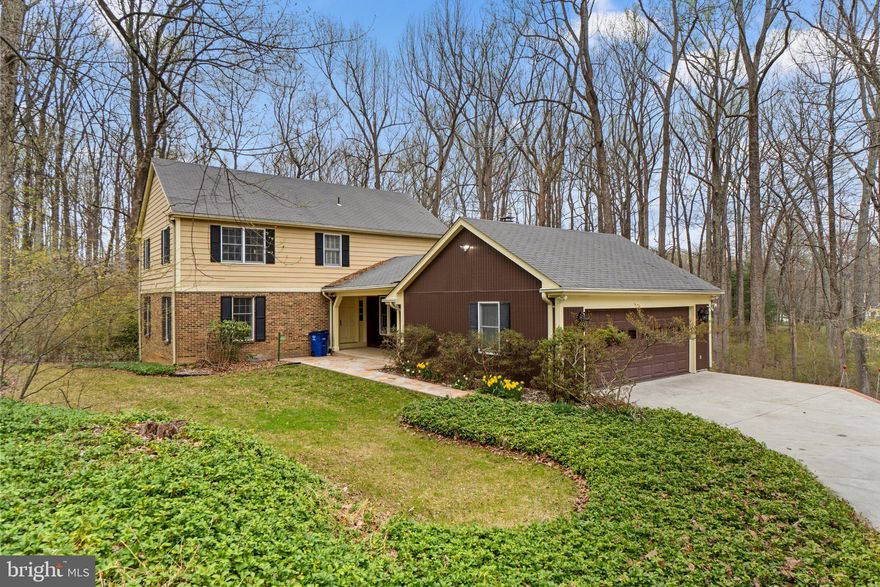 PRIME LOCATION!  Come see this great 4 bedroom, 2.5 bath home in the highly sought after neighborhood of Woodmark located in Ellicott City!  Set on 1.94 acres, with features that include:  gleaming hardwood floors throughout the huge living room with floor to ceiling windows to let in all of the light.  The dining room also has the wonderful hardwood floors, plus a huge bay window!  The foyer has 12" high quality European design tile, which leads you into the large kitchen complete with more ceramic tiled flooring, granite countertops, Birch wood cabinetry, built-in microwave, dishwasher, refrigerator, two pantries, and plenty of room for a kitchen table.  The family room is off of the kitchen and  has the wood-burning stove for cozy nights at home and has windows and sliding glass doors on both sides to keep it bright when you want it or blinds when you don't.  The sliding glass door leads you out to the large deck, perfect for entertaining and overlooking the very private backyard.  Back inside, the main level also has a powder room and a separate laundry room with a brand new washer and dryer.  The laundry room also conveniently has  a door out to the deck too.  Upstairs is where you will find 4 large bedrooms and 2 full bathrooms.  The bedrooms all have hardwood flooring too.  The primary suite is very generously sized and has a separate vanity area, great walk-in closet with plenty of room to spare, and an en-suite bathroom.   The lower level is huge and is a blank canvas for the new owners to finish and gain another 1,496 square foot of finished living space!  Don't miss the oversized 2-car garage with plenty of room for storage.   HVAC (gas) 2017, Hot water heater (gas) 2019,  Roof 2010, plus equipped with a clog-free gutters system installed by Leaf-Guard.  The concrete driveway was just replaced in 2020 with 4" thick concrete reinforced with steel rebar!  There are also motion sensored lights on the driveway, in front of the garage and breezeway.   This spacious home (2,688 Square feet)  has been lovingly maintained by the original owners and is ready for your personal touches!  You will feel like you live in the quiet country, yet you will have easy access to commuter routes, 32, I-70, 29, 40, 100 & I-95.  Plus so close to shopping, golf courses, Country Club & upscale dining. AND Howard County Schools too!  Professional photos and 3D scan coming soon!