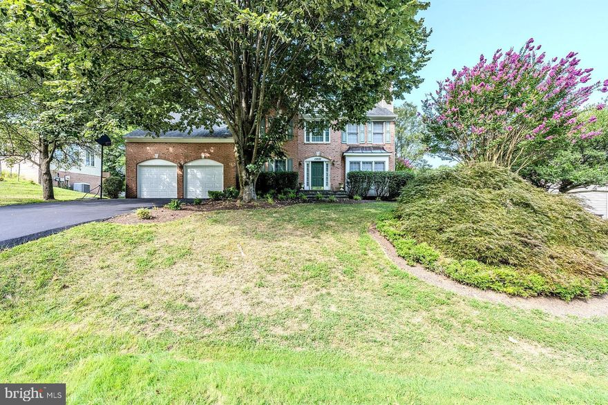 Step into this beautiful brick front colonial located in sought-after Naples Manor, where comfort meets style. This spacious residence features 4 bedrooms and 3.5 baths on 3 finished levels, designed to offer both luxury and practicality. ****** As you enter, you'll be greeted by a grand two-story foyer with rich hardwood flooring that sets the tone for the rest of the home. To the right, a generous library makes an ideal home office.  Opposite the foyer, the formal living room has a floor to ceiling box window, crown molding, and an elegant fireplace with marble surround. The adjoining formal dining room is accented by chair rail and a shimmering crystal chandelier adding refined style. The large open kitchen is a chef’s delight, boasting gleaming granite countertops, an abundance of pristine white cabinets, stainless steel appliances including a gas range, and a sizable pantry. A large center island provides bar style seating, and the adjoining breakfast area is the ideal spot for daily dining. Step down into the family room with a soaring vaulted ceiling with ceiling fan, wall of windows overlooking the back yard, and a cozy gas fireplace inviting you to relax and unwind. Here, a glass paned door grants access to a multi-area custom patio with built-in seating and the vibrant yard beyond dotted by majestic trees, seamlessly blending indoor and outdoor living. Back inside, a powder room and mudroom/laundry room with easy access to the two-car garage complement the main level. ****** On the upper level, the primary suite serves as a tranquil retreat with its separate sitting area, two large closets including a walk-in closet, and a luxurious bath complete with a cathedral ceiling with skylight, a dual sink vanity, water closet, separate soaking tub, and a glass enclosed shower. Down the hall, three additional spacious bedrooms share a well-appointed hall bath. The fully finished lower level is a highlight of this home, offering a sizable multi-area recreation room, a bonus room and convenient full bath making a great guest suite, and a two large versatile storage rooms. With a soft neutral color palette throughout, a newer roof and hot water heater, and a dual zoned HVAC system with a one unit replaced 6 years ago this home is move-in ready!  ****** All this in a tranquil community with lush common ground, walking trail, playground and more. Conveniently located near the ICC Glenmont Metro, shopping centers, and restaurants, this home provides the perfect blend of serene living and easy access to amenities. If you’re looking for an exceptional home in a spectacular location, this is it!