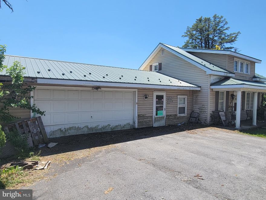 Own a home business... There are many possibilities as this home is located in the "general commercial" area of Gratz.  Previously this home had a printing business in the oversized garage.  This home is pre existing, which means it can be a residence and or a business.  A metal roof was installed over most of the home/garage, however the back of the garage was never completed.  Single floor living is possible as there is first floor bedroom, bathroom, and laundry area.  Bring a flashlight and bring your ideas as its time to get creative.  Cash Only Please, the property is being sold as-is and the personal property can be removed, however it's preferred to remain.