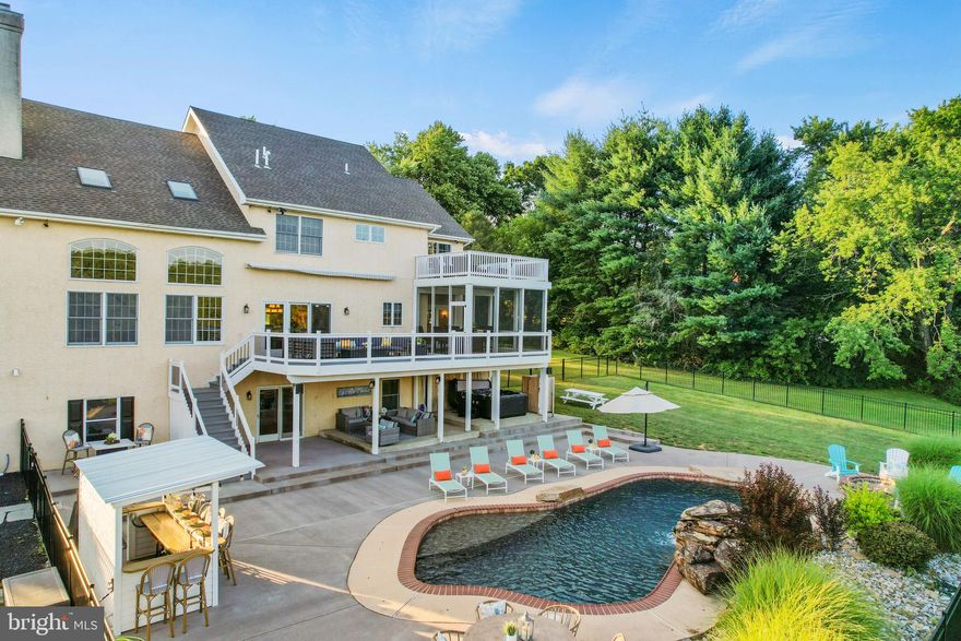 Your private oasis awaits at 113 Round Hill Road; a hidden gem in scintillating Kennett Square! This elegant home boasts 4 sizable bedrooms and 4.5 bathrooms. At first glance, the curb appeal of the stone and stucco exterior draw you into the large front porch, and beautifully ornate glass front door – the perfect greeting to a home. Upon entrance, the house contains polished hardwood floors below your feet and a glistening chandelier crowing the winding stairway. To the right lies a private office and to the left, a spacious seating room that leads to the formal dining room where you can escape to the enclosed porch and enjoy the outside behind gentle screens. The dining space opens up to a gourmet kitchen equipped with custom cabinetry, shining granite countertops, upgraded appliances, and an island with seating. The other side of the kitchen contains a prep sink and additional counter space, a wine rack, and cabinets; more storage space, and tools to create a perfect kitchen experience. The open concept kitchen has a breakfast area near sliding glass doors that lead to a large deck with retractable awning that overlooks the backyard retreat and rolling hills. Beyond the eating area is the expansive Great Room with propane fireplace and custom mantle that soars up to the cathedral ceiling with skylights that flood the room with light. This space is lined with large, two-story windows and an additional stairway to the second floor. The mudroom next to the stairs contains a built-in cubby space and a bench by the doorway to the two-car garage. A small hallway leads to the first of three laundry areas.  The laundry locations are on the first, third and and lower levels; while the second floor has a laundry chute conveniently located in the loft. 

Four bedrooms and three bathrooms are situated on the second floor. Two of the smaller bedrooms have ensuites. The large guest suite can be found right off of the loft area. The Primary Bedroom with en suite provides a seating area and secluded deck for quiet moments, yoga, or meditation. The ensuite has a double vanity, soaking tub, and a separate shower. Private stairs lead to a third floor dressing room lit with stunning chandeliers and equipped with laundry facilities and a prep sink. 

The lower level has a full kitchen, bonus room, full bathroom, exercise room, and theater area with surround sound. The walk-out sliding doors lead out to the breathtaking backyard space with nine areas of entertainment. Within the core of this backyard mecca is a heated in-ground pool that instantly captivates the viewer with its sun shelf, diving rock, and flowing waterfall feature. Along the side, the newly redone patio offers additional space for seating and hosting. Guests can enjoy the hot tub or utilize the outdoor shower. Near the pool, the tiki bar provides shelving, a prep sink, mounted TV, and an extra refrigerator. To complete this at-home paradise, the backyard is outfitted with a shed, basketball court, and hardscaped fire pit area.

In addition to these amenities, this great escape is located close to the vibrant borough of Kennett, Longwood Gardens, restaurants, shopping, transportation, and is within the Kennett Consolidated School District. This is the lifestyle you deserve; come meet your future home.

* * * This home is Active/Under Contract - Allowing Showings on Saturday * * *  
Backup Offers Accepted.