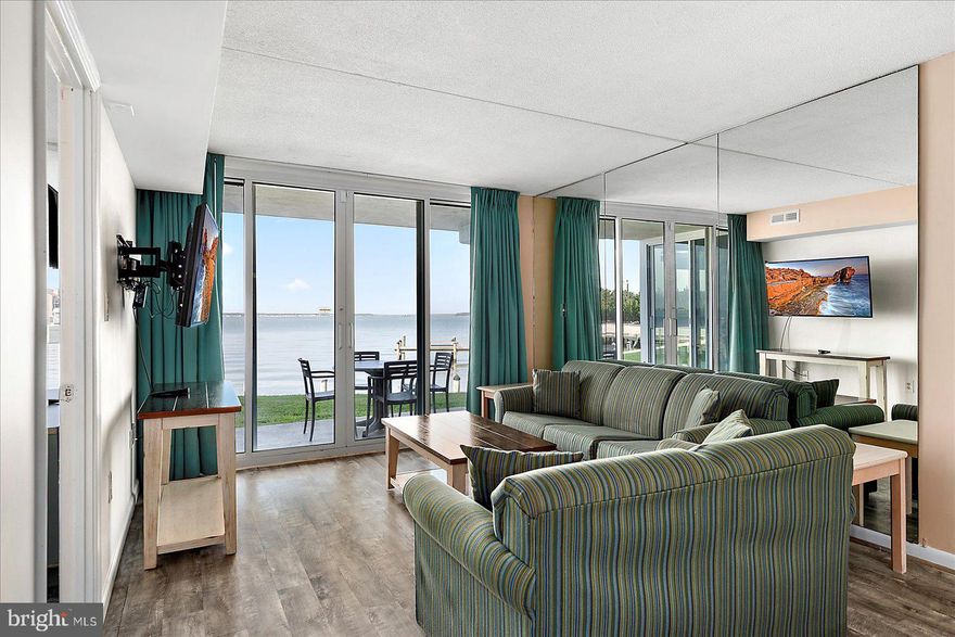 Welcome to your perfect Bayfront getaway! This gorgeous 2-bedroom, 2-bath condo is everything you've been dreaming of. From the moment you step inside, you’ll be captivated by the stylish kitchen featuring solid wood cabinets and elegant countertops—ideal for preparing your favorite meals. The combination of tile, luxury vinyl plank,  and carpet flooring adds warmth and comfort throughout. Convenience is key, with a full-size washer and dryer in-unit, making laundry day effortless. The primary bedroom is your personal sanctuary, offering corner windows that bathe the room in natural light. Open the sliding door, and you’ll find yourself on the balcony, soaking in spectacular bay views—imagine waking up to this tranquil setting every day.  The building offers a wealth of amenities to enhance your lifestyle, including a year-round indoor heated pool, perfect for year-round relaxation.  One parking spaces provide convenience and peace of mind, additional parking spaces by request,  and with professional on-site management and maintenance, you can rest assured that all your needs are taken care of. The condo fees cover water, cable, and internet, offering added value. The property has recently undergone a series of beautiful renovations, including new windows, sliding balcony doors, updated lobby, exterior, and balconies, adding a fresh and modern touch to your new home.  Don’t miss the chance to make this beautiful Bayfront condo your own and experience the ultimate in coastal living.