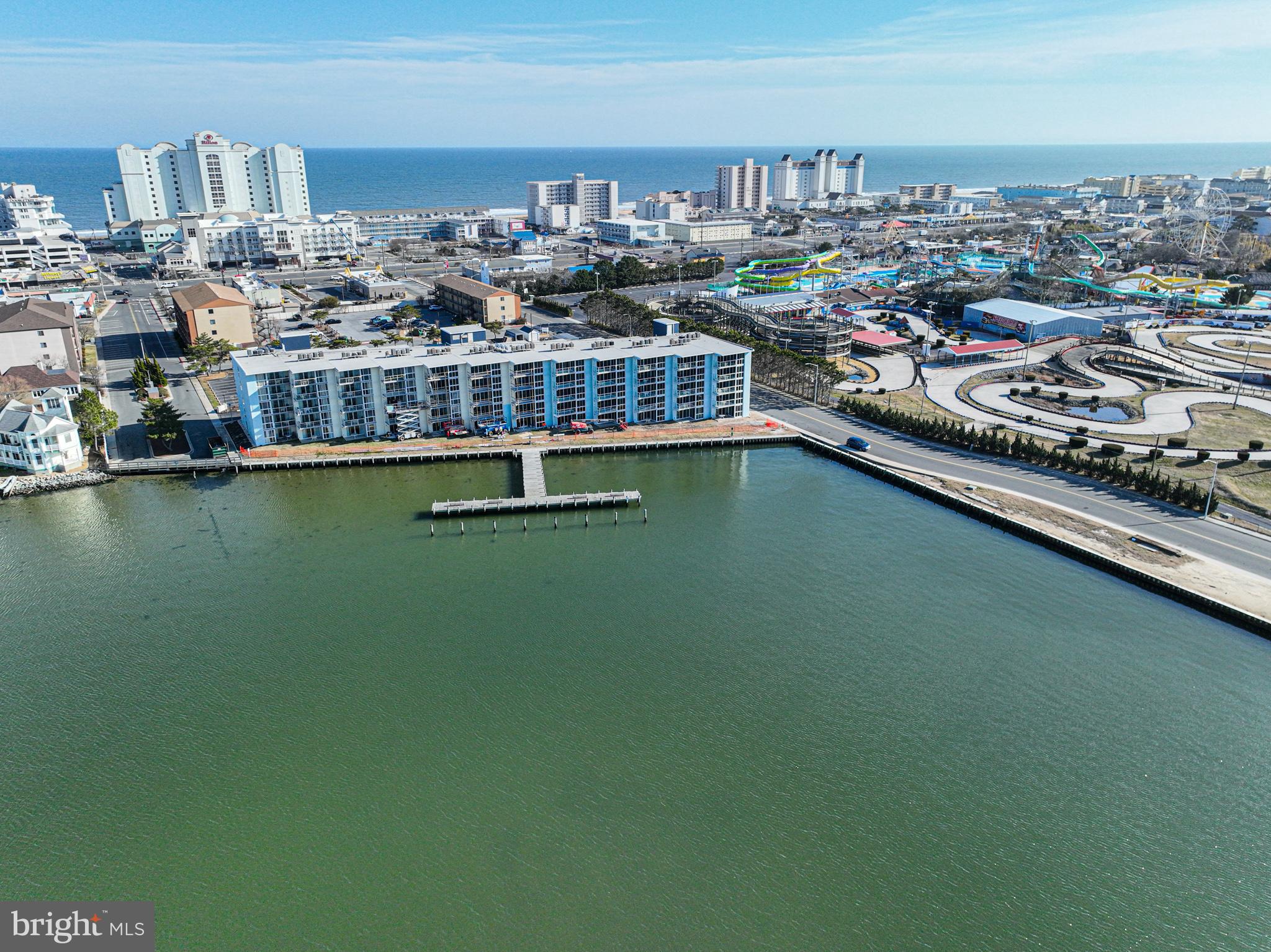 Welcome to your perfect Bayfront getaway! This gorgeous 2-bedroom, 2-bath condo is everything you've been dreaming of. From the moment you step inside, you’ll be captivated by the stylish kitchen featuring solid wood cabinets and elegant countertops—ideal for preparing your favorite meals. The combination of tile, luxury vinyl plank, and carpet flooring adds warmth and comfort throughout. Convenience is key, with a full-size washer and dryer in-unit, making laundry day effortless. The primary bedroom is your personal sanctuary, offering corner windows that bathe the room in natural light. Open the sliding door, and you’ll find yourself on the balcony, soaking in spectacular bay views—imagine waking up to this tranquil setting every day. The building offers a wealth of amenities to enhance your lifestyle, including a year-round indoor heated pool, perfect for year-round relaxation. One parking spaces provide convenience and peace of mind, additional parking spaces by request, and with professional on-site management and maintenance, you can rest assured that all your needs are taken care of. The condo fees cover water, cable, and internet, offering added value. The property has recently undergone a series of beautiful renovations, including new windows, sliding balcony doors, updated lobby, exterior, and balconies, adding a fresh and modern touch to your new home. Don’t miss the chance to make this beautiful Bayfront condo your own and experience the ultimate in coastal living.