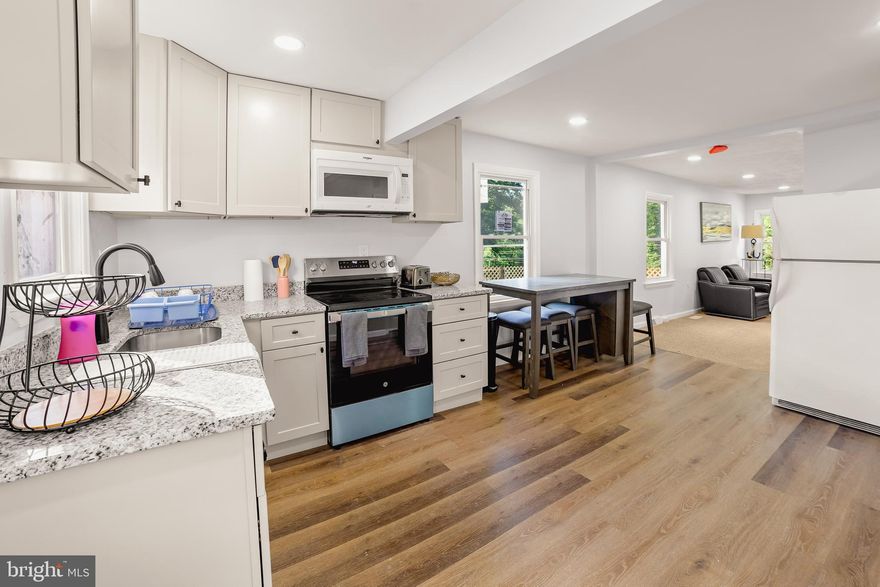 Very nice home with 4 bedrooms, 2 full bathrooms, and 2 kitchens!  Basement has a separate apartment with a New kitchen, New bathroom, living room, and a bedroom.  Upstairs has a New kitchen, New bathroom, 3 small bedrooms, and a large living room. 
Large .33 acre lot with tons of parking out back.  The property back up to the desired B&A Trail.  Take a nice peaceful morning walk for coffee in downtown Severna Park.  Prime location only 2 minutes from many shops and restaurants.  10 minutes from Annapolis.  Severna Park Schools.  

New recess lighting throughout.  Fresh paint.  New LVP flooring.  New egress window in basement bedroom.  New gas furnace and new central AC!  New front deck.  New washer and dryer.

Garage is As-Is and needs repair.  The large flat back lot gives you lots of options for building an addition, an ADU, repairing the garage or building a new garage with an extra living space!  Or just enjoy an oversized yard backing up to the trail!