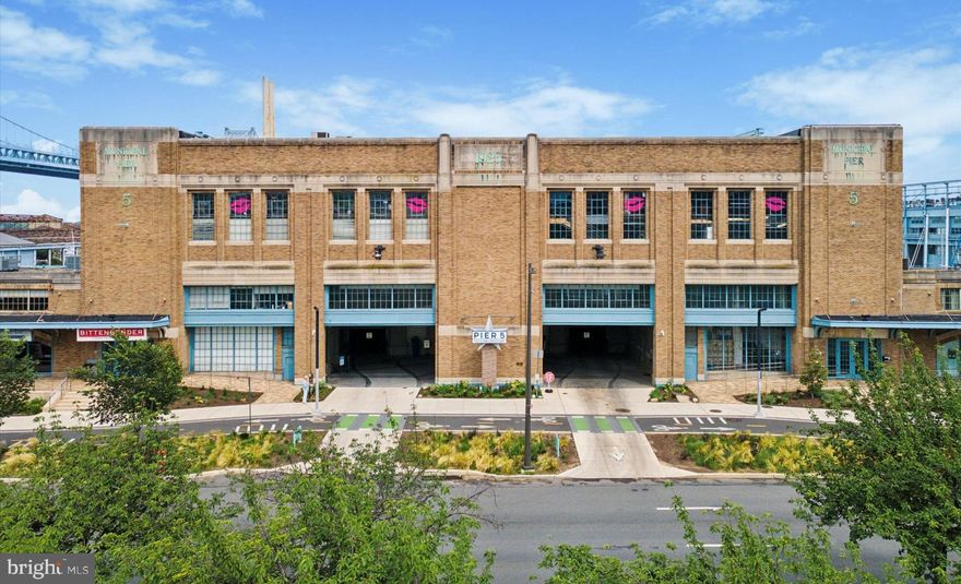 Welcome to Pier 5 — Waterfront Living in the Heart of Philadelphia.  Discover this spacious and light-filled two-bedroom, two-and-a-half-bath condominium at sought-after Pier 5 on the Delaware River in Penn’s Landing. This exceptional home offers a unique blend of tranquility and city excitement, featuring bright, open living spaces accented by a warm fireplace and timeless neutral tones throughout. Enjoy cooking and entertaining in the recently updated kitchen, thoughtfully designed with modern finishes and ample storage. Each of the two generous bedrooms offer new carpeting and include their own own en suite baths, providing privacy and comfort for residents and guests alike. Step outside onto your private deck overlooking the river and marina — the perfect spot to relax and take in the views.  Convenience is key, with your dedicated garage parking space located adjacent to your private lower-level entry. A utility area next to the garage makes loading and unloading groceries a breeze, and the convenient ground-level laundry room adds to the home’s effortless livability.  Residents at Pier 5 also benefit from impressive building-wide upgrades currently underway, including large-scale renovations to the interior common spaces of the Pier, and the re-creation and re-installation of the Pier’s iconic and stunning atrium garden. Once completed, this lush green oasis will offer residents a peaceful retreat just steps from their front door — a perfect complement to the waterfront setting. In addition, the building features a beautifully maintained riverfront common terrace that spans the entire Delaware River side of the property — an ideal gathering place for morning coffee, sunset cocktails, or entertaining guests. This spectacular space offers sweeping views of the water and the iconic Benjamin Franklin Bridge, creating a one-of-a-kind backdrop for daily living.  Step outside your door and enjoy all that vibrant Penn’s Landing has to offer: riverside parks, seasonal events, waterfront trails, Spruce Street Harbor Park, Blue Cross RiverRink, and a wide variety of restaurants, cafes, and entertainment options. You’re just minutes from historic Old City, lively South Street, and the best of Philadelphia’s shopping, dining, and cultural attractions. Commuting is effortless with quick access to I-95, I-676, major bridges, and public transportation, connecting you seamlessly to Center City and beyond.  Please note that the interior common spaces of the Pier are currently undergoing significant renovation.  Images of the gardens were taken prior to the start of the renovations.  Don’t miss this opportunity to enjoy the best of waterfront living with the comfort, convenience, and excitement of city life at your doorstep.  Schedule your private tour today and experience Pier 5 for yourself!