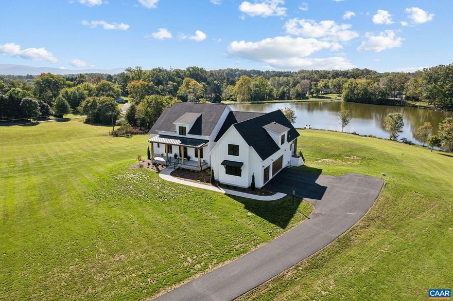 Captivating lakefront custom-built residence on 5.97 acres in Albemarle County. Completed in 2023, this turn-key home exudes luxury from top to bottom, showcasing designer appointments throughout. Its contemporary style beautifully complements the stunning water views visible from each & every picture window. Enjoy expansive lake vistas and your own private dock for relaxing afternoons or evenings. The sought after open floor plan features 10' ceilings, creating an unparalleled atmosphere for beauty, comfort, and entertaining. Main level includes two elegant bedroom suites, a dedicated home office, and a convenient third suite on the second level. The chef's kitchen is a remarkable centerpiece: high-end stainless steel appliances, oversized island with seating, custom cabinetry, & quartz countertops. A bright and inviting breakfast area seamlessly flows into the kitchen, perfect for casual dining and the enormous custom walk-in pantry is a showstopper. The walkout terrace level is equally impressive, featuring two additional bedrooms, sunny gathering room, kitchen & a full bath?each with marvelous lakefront views. This residence is not just a home; it's a serene retreat, designed for those who appreciate the finer things in life.,Quartz Counter,Wood Cabinets,Fireplace in Great Room