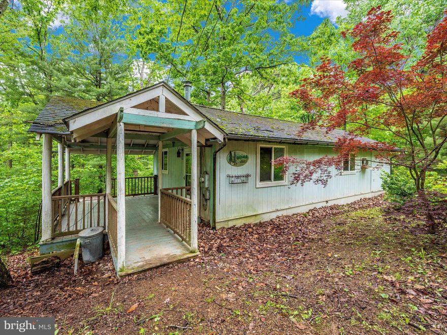 Imagine stepping onto the porch of this charming cabin nestled within the tranquil embrace of Glenwood Forest. As you approach the entrance, the air is crisp, carrying the scent of pine and earth.  The living room and kitchen merge seamlessly into one another, creating an inviting space for relaxation and culinary adventures. The wood-burning stove is the centerpiece, filling the room with a comforting warmth.
Moving further into the cabin, you find yourself in the spacious bedroom with large windows that offer glimpses of the forest outside, allowing the natural beauty to permeate every corner of the room.  Ah, a multi-functional space in this cozy cabin, the bathroom and laundry area share a common space, combining convenience with practicality. 
Outside, the porch offers a peaceful retreat, where you can sit in a rocking chair, sipping on a cup of hot cocoa as you listen to the gentle rustle of leaves and the distant chirping of birds. Surrounded by nature's embrace, this cute cabin in Glenwood Forest is a haven of tranquility, inviting you to escape the hustle and bustle of daily life and immerse yourself in the beauty of the great outdoors.   With a little TLC, this cozy retreat could be your, ready to welcome weary travelers seeking solace amidst the beauty of Glenwood Forest.  PLEASE CALL VALERIE FRANKLIN FROM PRIME LENDING TO ASK ABOUT THE FHA203K LOAN!!