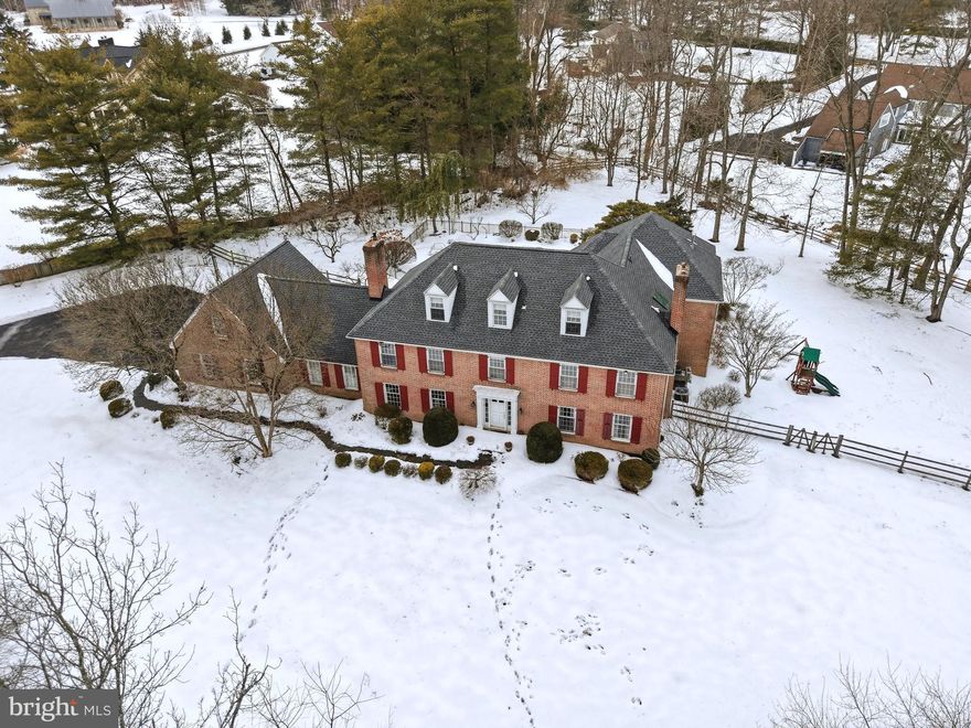 Tucked away in an exclusive enclave off Sheaff Lane, this custom-designed brick estate redefines luxury living. With over 6,500 square feet of exquisite interiors on 1.5 acres of lush, manicured grounds, this home is a private retreat where timeless elegance meets modern sophistication.

A long, tree-lined driveway leads you to this serene sanctuary. Inside, rich hardwood floors flow seamlessly throughout the main level, creating a warm and inviting ambiance. The expansive dining room, centered around a wood-burning fireplace with a classic brick surround, invites cozy gatherings, while the nearby office, complete with a built-in desk, opens into a stunning new great room. Flooded with natural light from wall-to-wall windows, the great room features custom built-ins, a gas fireplace with a striking stone surround, and charming window seats. French doors lead to a covered patio, where breathtaking views of the sprawling backyard await.

At the heart of the home is a chef’s dream kitchen, blending style and functionality. Highlights include a grand central island with a 5-burner cooktop, custom Amish-crafted cabinetry, two full-size built-in Sub-Zero refrigerator and freezer units, Viking wall ovens, a Thermador gas cooktop, a Bosch dishwasher, and a stunning oversized copper farm sink. A built-in window seat overlooking the serene landscape is the perfect spot for morning coffee. Adjacent to the kitchen, a cozy sitting area with a wine fridge and dry bar sets the tone for entertaining, while the den, with its wood-burning fireplace and beadboard accents, offers a warm haven for relaxation.

Upstairs, the luxurious primary suite is a peaceful escape, featuring a tray ceiling, a private sitting nook with a gas fireplace, and dual custom walk-in closets. The spa-like ensuite bathroom boasts radiant heated floors, ton of natural lights from the skylight, a Jacuzzi tub, a tiled stall shower, and a double vanity. A second ensuite bedroom and two additional bedrooms with walk-in closets offer ample space, while the upstairs laundry, cleverly integrated into a full bathroom, adds ultimate convenience. A spiral staircase connects the upper level to the great room below, and a finished attic with cathedral ceilings provides endless possibilities for a bonus space. The massive basement offers abundant storage or potential for additional living space.

Step outside, and you’ll find your own private oasis. The beautifully landscaped backyard features a sparkling in-ground pool with a brand-new heater and spa pump, offering year-round enjoyment. Multiple covered porches provide the perfect settings for al fresco dining or unwinding with a good book. Whether hosting lively summer gatherings or savoring quiet evenings under the stars, this outdoor space is truly enchanting.

This home is more than a residence—it’s a lifestyle. Every detail has been meticulously crafted to deliver unparalleled comfort, privacy, and efficiency, with six heating zones and four A/C zones ensuring optimal climate control year-round. Perfectly situated in a prime location, the property offers a rare balance of seclusion and convenience. Just minutes from regional rail, major highways, and the vibrant downtown Ambler area, you’ll have access to an abundance of restaurants, shops, the Wissahickon trails, and Germantown Academy’s expansive campus. Plus, enjoy the benefits of low Whitemarsh Township taxes.

Don’t miss the chance to make this extraordinary property your own. Schedule your private tour today and experience the magic of this spectacular home!