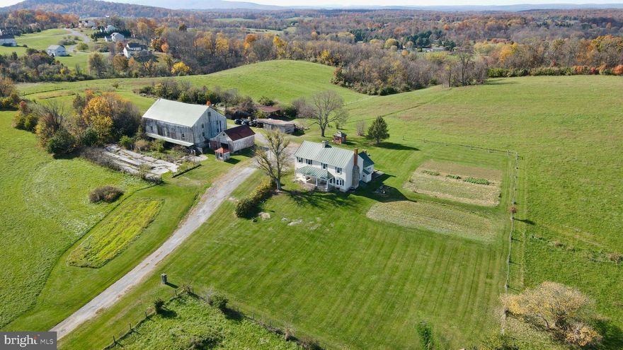 Welcome to this beautiful farmhouse resting on rolling land with stunning mountain views. This 4 Bedroom 1.5 bath has just shy of 3000 sq ft of living space with hardwood flooring, a country kitchen with walk in pantry, formal dining room, Family Room and Living Room on the main level. Upper level has 4 Bedrooms and 1 shared bath. Property has a barn and storage, Relax out back on the patio or enjoy the view from the covered front porch. Listen to the rainfall on the metal roof!