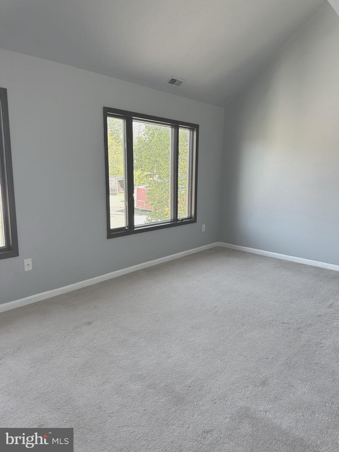second floor apartment with vaulted ceilings in living room and loft bedroom. Small 2nd bedroom with no windows off loft, good for an office also. Full kitchen. Laundry room is on the same floor and shared by all 4 apartments. parking lot in rear of building. This unit is in a commercial zoning above offices.