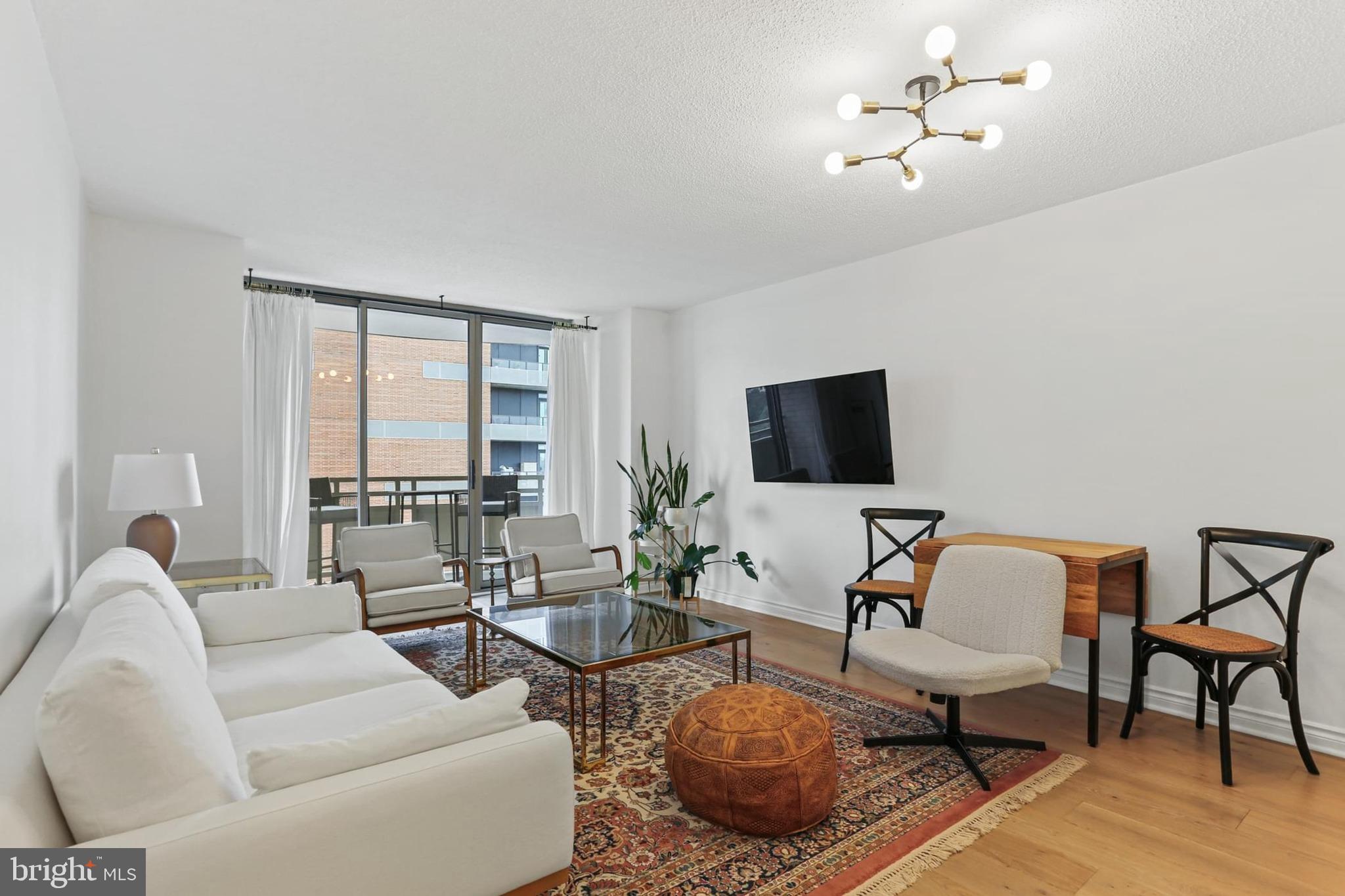 Discover elevated urban living in this completely remodeled 1-bedroom, 1-bath condo located at 4801 Fairmont Ave in the heart of downtown Bethesda. Thoughtfully redesigned from top to bottom, this stunning residence offers a seamless blend of modern finishes and functional living—just steps from the Bethesda Metro Station and blocks from NIH. With a Walk Score of 96, you're perfectly positioned to enjoy some of the area’s best restaurants, cafes, and nightlife, including local favorites like Black’s Bar & Grill, Woodmont Grill, Ala Bethesda, and Pizzeria Da Marco.
Inside, the home features wide plank French white oak hardwood floors, fresh designer paint, all-new lighting, and a fully updated kitchen with quartz countertops and sleek cabinetry. The bathroom has also been transformed with modern quartz surfaces and stylish fixtures. An Ecobee smart thermostat adds energy efficiency, while custom Elfa closet systems from The Container Store offer premium storage solutions. The bright, open layout is filled with natural light and opens to a refreshed private balcony—ideal for relaxing or entertaining. Garage parking is available in the building for an additional monthly fee (\$180 for one space, \$220 for two). Offering luxury, location, and lifestyle, this beautifully remodeled condo puts you at the center of everything downtown Bethesda has to offer.