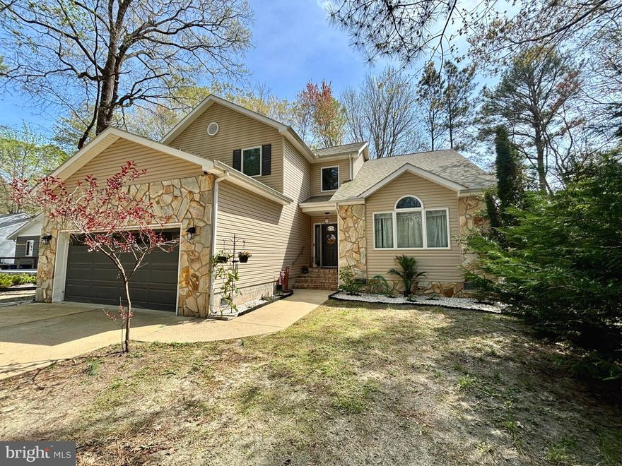 Stop by Saturday, April 18 for the OPEN HOUSE 11am-1pm and make an offer on this coastal beauty!  This home feels so custom, so grand and ready for you to kick off your shoes and relax. As you walk up you will notice the cool stone siding and all the interior upgrades including: the flooring (2022), the designer lighting and coastal cozy details of this home.  You are greeted with a dramatic vaulted ceiling in the living room, complete with gas fireplace making this an entertainer’s dream. The oversized dining room off of the custom kitchen and breakfast area really provides ample space for all your needs. Updated appliances and washer/dryer were added in 2023. With 4 bedrooms, including the primary bedroom on the main floor, plus an additional 2nd floor rec room, you will have a room for everyone to unwind. Check out the attic space! Your 2-car garage is nicely epoxied (2022) and ready for all your beach gear! Updates include a new HVAC in 2026 and crawl space dehumidifier in 2024. At over 3000 square feet, this coastal beauty in South Ocean Pines offers community amenities including several amazing pools, tennis courts, a marina, yacht club, golf course, parks, trails and so much more! This is truly a must see!