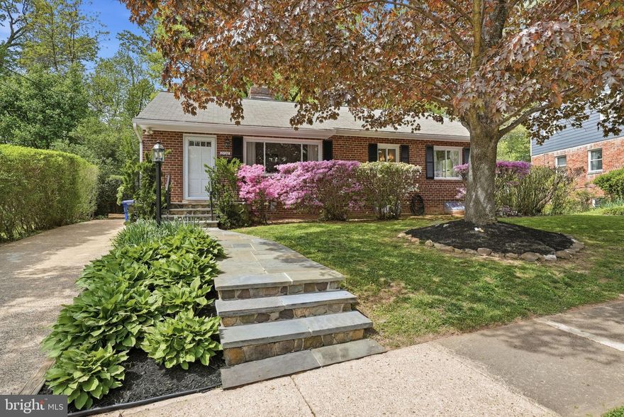 One-level living with a finished basement, set within beautifully established landscaping that creates a private, garden-like setting. Mature azaleas, dogwoods, and layered plantings frame both the front and rear yards, offering seasonal color and a true sense of retreat.

The main level features an open living, dining, and kitchen layout, anchored by a fireplace and filled with natural light. The updated kitchen includes an island, granite countertops, painted cabinetry, stainless steel appliances, and a window overlooking the backyard and terrace. Three bedrooms and a full hall bath with a tub/shower are also located on this level, including a rear-corner primary bedroom with dual exposures and peaceful backyard views.

The lower level offers additional living space with a large rec room featuring built-ins and above-grade windows, a full bath with a jetted tub, a spacious laundry room with an extra refrigerator and abundant shelving, and a partially finished storage area.

Outdoor living is a standout, with a screened porch, private terrace for dining and grilling, and a deeply planted yard that feels both lush and intentional. The non-buildable lot behind the property adds an extra layer of privacy and uninterrupted green space.

The property sits on a combined .23-acre lot spanning two tax IDs — one in Arlington County and one in Falls Church City — offering flexibility in school district selection.