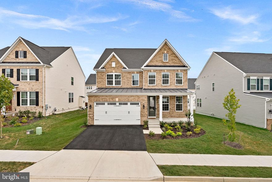 Welcome to Tuscarora Crossing! This one-year-young single-family home showcases the Baldwin floor plan, offering three finished levels, 5 bedrooms, 4.5 bathrooms, and nearly 4,500 square feet of luxurious living space filled with upgrades throughout. Step into the elegant foyer, where a stylish office makes an immediate impact. A powder bath with linen closet and coat closet complete the entryway before leading into the open-concept main level. Here, you’ll find a formal dining room, sun-filled family room with additional windows and fireplace complimented by floor-to-ceiling stone. breakfast area, and a truly stunning gourmet kitchen. The kitchen features abundant cabinetry, quartz countertops extended up to the backsplash, a waterfall island, ceramic white-apron farmhouse sink, pendant lighting, hardwired under-cabinet lighting, upgraded stainless-steel appliances, and a walk-in pantry. Off the two-car front-load garage, a mudroom with hooks, storage, and an additional coat closet keeps daily life organized. The entire main level is finished with luxury vinyl plank flooring. From the family room, step out to a large, full Trex covered deck complete with a striking floor-to-ceiling stone fireplace and mantle. The deck overlooks a spacious backyard - perfect for entertaining, letting the dog run, or giving kids plenty of room to play. Upstairs, oak stairs lead to a spacious hallway also upgraded with luxury vinyl plank flooring. Two bedrooms share a Jack-and-Jill bath with quartz-topped dual-vanity sinks and a private shower/toilet space. The expansive primary suite boasts a tray ceiling, added recessed lighting, two walk-in closets, and a spa-like bath with quartz-topped dual vanities, soaking tub, upgraded tile, and a frameless glass shower. A convenient laundry room with an added sink and cabinetry is located nearby. A fourth bedroom with its own walk-in closet and full quartz-topped vanity bathroom completes the upper level. The finished basement offers upgraded carpeting, a large recreation area, and an impressive wet bar with wine fridge, sink, dishwasher, shelving, and cabinetry - perfect for entertaining. The rec area is also wired for a projector! A fifth bedroom with walk-in closet and full bath, plus a massive storage room, round out the lower level. Community amenities currently include a tot lot, fire pit, and a walking path connecting you to the W&OD trail. Perfectly located off Route 7, this home is within walking distance to Village at Leesburg shopping, dining, and entertainment. Enjoy being just five minutes from the Leesburg Outlets, 10 minutes from Downtown Leesburg, and under 10 minutes from One Loudoun. This Tuscarora Crossing beauty combines thoughtful design, high-end finishes, and an unbeatable location - ready to welcome you home!