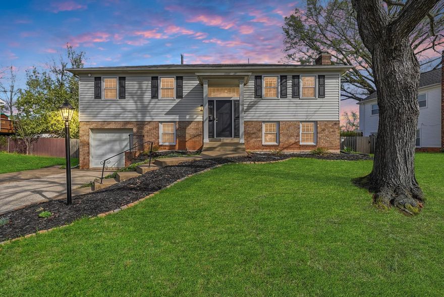 This charming split foyer home in the desirable Sudley neighborhood has been thoughtfully and beautifully renovated, blending modern comforts with classic appeal. Step inside to discover a warm and inviting atmosphere, highlighted by beautiful hardwood on the main level and luxury vinyl plank flooring downstairs. The open floor plan seamlessly connects the kitchen, living, and dining areas, creating an ideal space for both entertaining and day to day living. The kitchen is a chef's dream, boasting new bright and white cabinets, upgraded quartz countertops, a convenient island, and stainless steel appliances. Enjoy quiet moments sipping your coffee and reading a good book in the adjoining sunroom. The primary suite offers a private retreat with two closets, an en-suite updated bathroom featuring a stall shower, while two additional bedrooms provide space for family or guests or a home office. A unique laundry chute in the hallway adds convenience to your daily routine. The partially finished basement allows for cozy entertaining space around the fireplace with additional flex space for a playroom, home office, storage etc with access to the backyard. With an attached garage and driveway parking, and a workshop area off the utility room, you'll have plenty of space for vehicles, crafts, and hobbies. Outside, the fully fenced lot offers a serene setting, perfect for pets and outdoor activities or simply unwinding after a long day. This home is not just a place to live; it's a place to create lasting memories. Don't miss the opportunity to make it yours!