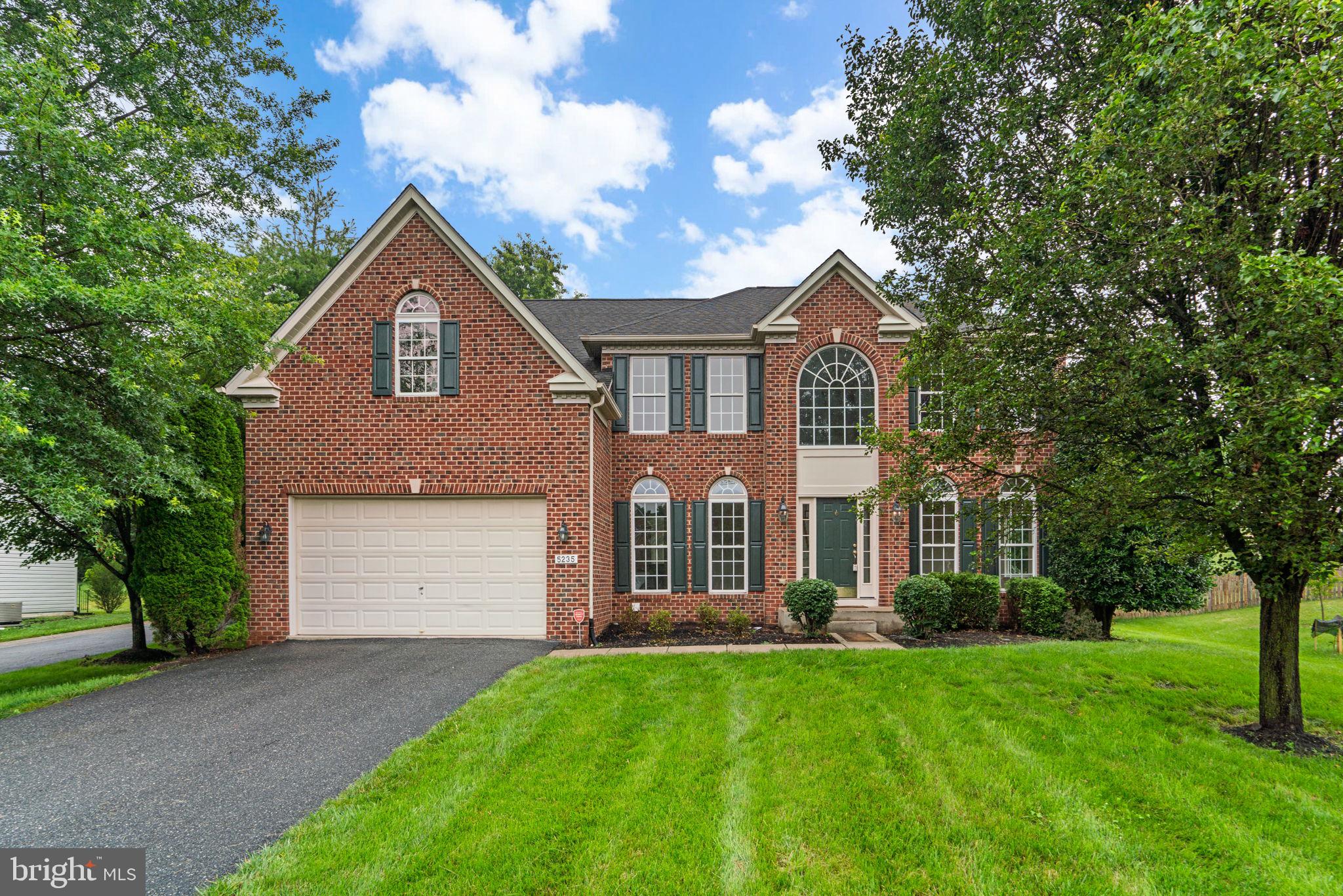 Welcome to this beautiful brickfront residence situated on a .32-acre homesite in Howard County’s Dennis Preserve community. Great curb appeal introduces this stately brick home presenting three finished levels and over 4,892 finished square feet of living space with gleaming hardwood floors, trimwork and mouldings, brilliant natural light, and an ideal neutral palette ready for your personal touch.
Step inside the immaculate interior to find a two-story foyer, a formal living room with columns and a bay window, a formal dining room, and a huge family room with a stone surround gas fireplace. At the center of it all is the enormous kitchen equipped with stainless steel appliances, ample cabinetry and counters, recessed lighting, a center island with breakfast bar, a large pantry, and a bright morning room with an array of gorgeous windows and a door leading outside to the backyard.Additionally, the main level features a study with French doors, a powder room, and a laundry room.
The primary suite is truly an owner’s retreat for relaxation. This expansive room showcases a tray ceiling and elegant columns, sun-drenching windows, a large sitting room, a large walk-in closet, and a private bath with dual vanities, a tub with tile surround flanked by elegant columns, and a separate walk-in shower with a built-in seat. In addition to the primary suite, the upper level hosts three additional bedrooms. One bedroom includes a private attached bath, and the other two bedrooms share an attached dual-access bathroom.
The lower level boasts a massive rec room with a gas fireplace, a sitting area with walk-up access to the backyard, a bonus room or potential guest bedroom, a full bathroom, and a large unfinished space ideal for storage. Outside, the front and back yards both offer open and level space for outdoor entertainment and enjoyment. Let your new memories begin here…welcome home!
