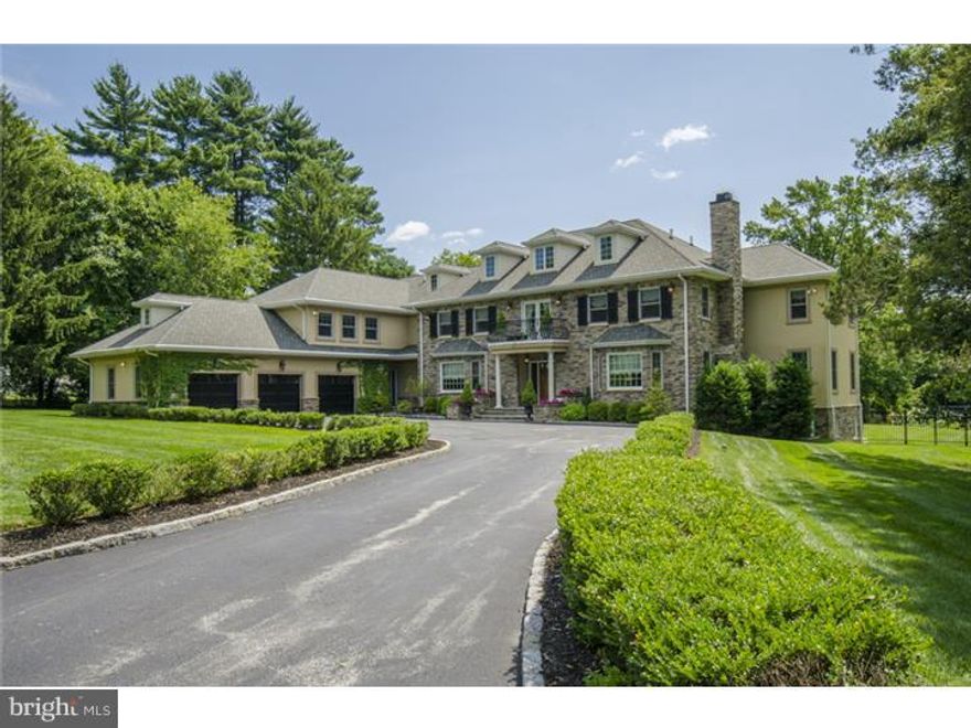 Three wide stairs lead to a covered entry and beyond to a grand Foyer with straight through views to the property's 1.2 /- acres and rear yard. To the right of foyer is the formal Living Room with custom shelving, wainscoting and gas burning fireplace with Verdi marble surround. A privacy door opens from the Living room to the Library/ Billiard room highlighted by coffered ceiling, seated storage bench and concealed television making this handsome space appropriate for work or recreation. To the left of Foyer, through a gently arch, find an elegant Dining Room with deep wainscoting and service connection to a full Butler's Pantry including glass display cabinetry, wine refrigeration and under mounted sink with glass tiled backsplash. Gleaming all white kitchen with bianco granite counter tops offers exquisite detailing and well planned functional space. An oversized seated island with 4 inch thick granite top is paired with commercial quality appliances including six burner Viking gas cooktop with griddle and pot filler, double wall ovens, inset microwave, warming drawer and Viking brushed stainless refrigerator. Steps from kitchen area is a large breakfast room with access to the rear pacer terrace.  Wraparound windows bathe this room in natural light & a French door allows for access to the terrace and rear yard. Adjacent to the kitchen & off the rear Foyer is a generous family Room with Limestone surround fireplace, hardwood floors and full wall of glass. A large Mudroom off the Kitchen connects to the homes 3 car attached Garage & offers full sized Laundry, walk-in closets and shelved Pantry. The office is outfitted with double seated work space, granite counter and overhead storage cabinetry. Ascend the main stair to an expansive master bedroom suite complete with sitting room with balcony overlooking front courtyard. Large bedroom offers privacy through a pocket door to the dressing room with seated marble topped make up area and his and her outfitted a closets. A bright master bath offers double vanity wash stand height sinks and jetted tub and seated Carrera marble shower with seamless glass enclosure. Hardwood floors throughout the mater suite add warmth to this space. Four other bedrooms all with en suite baths are also on this level along with second full sized laundry and ample storage. Third level offers a finished office space and floored storage. Fully finished LL has a large recreation room, mirrored gym, bedroom w/outside exit & full Bath.