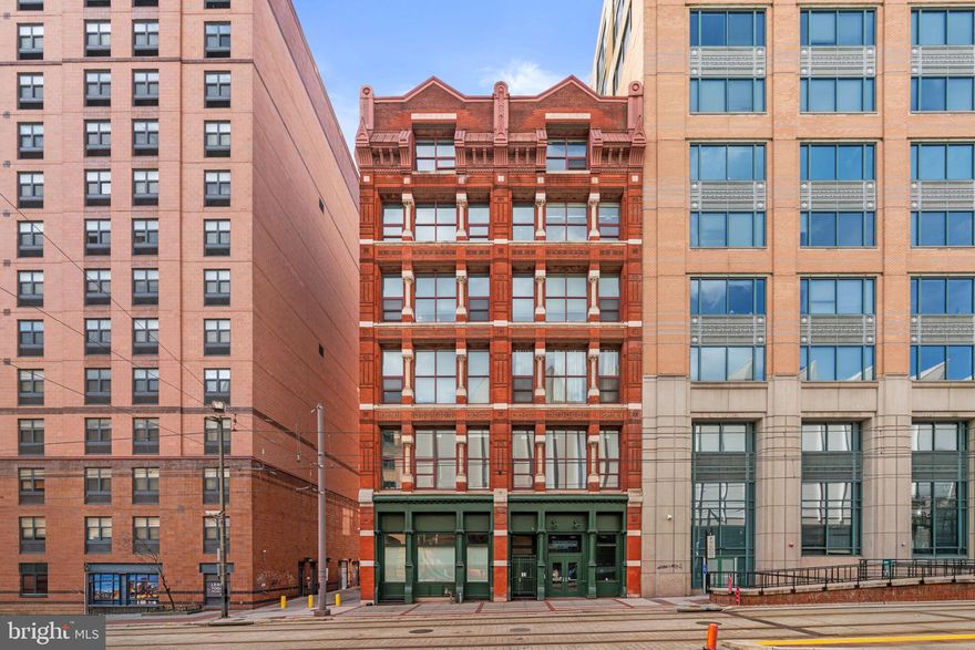 Welcome to 22 S Howard Street #R403, located in the historic Rombro Loft building in the heart of downtown Baltimore. Perfectly situated just steps from the University of Maryland campus, Oriole Park at Camden Yards, CFG Bank Arena, Ridgely’s Delight, and countless restaurants, shops, and entertainment options, this location offers the best of city living.

This beautifully remodeled condo is truly one of a kind within the building. The home features soaring ceilings, large windows that fill the space with natural light, and durable waterproof luxury vinyl plank flooring (installed in Dec 2025) throughout. Stylish barn doors add unique character, while the thoughtfully designed layout offers two spacious bedrooms, each with walk-in closets featuring custom built-ins. The home was freshly painted in 2026, giving the space a clean and modern feel.

The kitchen is equipped with stainless steel appliances and opens nicely to the living area, creating a comfortable space for everyday living or entertaining. Additional highlights include an in-unit washer and dryer.

The building features a brand new elevator with smart access, adding modern convenience and improved accessibility for residents. While the building does not have its own parking garage, several garages surround the building and spaces are available for rent nearby. This distinctive condo offers charm, convenience, and unbeatable downtown access.