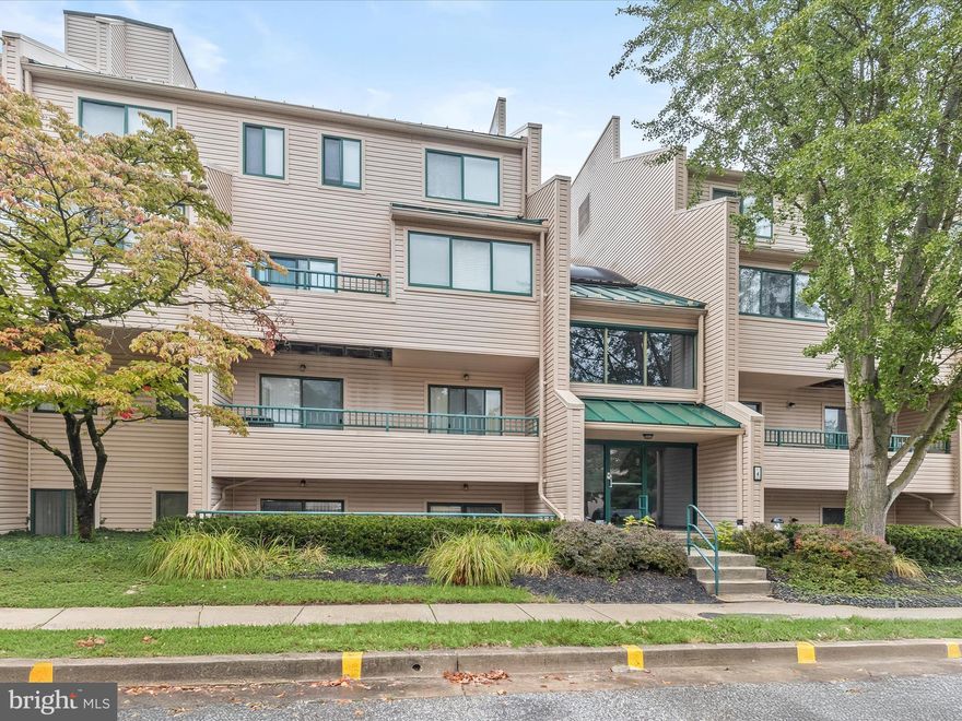 Welcome to this two bedroom, two bathroom first-floor condo in The Club at McDonogh, lovingly cared for by the original owner. Enter inside where a spacious living room with double sliding glass doors opens to the front patio, creating a bright and comfortable space for everyday living. The eat-in kitchen features a pantry, dining area, and laundry room, along with access to the rear patio. The primary suite includes a large walk-in closet and a private bathroom with dual vanities and a walk-in shower. A second bedroom offers flexibility as a guest room, office, or den, with a full bathroom across the hall complete with a tub/shower. The secure building lobby and ample parking add peace of mind, while the prime location keeps shopping, dining, and entertainment options close at hand.