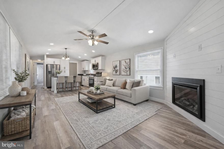 Jan 17 Open House Cancelled due to Weather.  Welcome to this beautifully renovated 2-bedroom, 2-bath mobile home-style ranch, thoughtfully updated with a bright, open-concept layout designed for modern living. The inviting main living space features an electric fireplace with ship lap feature wall that adds warmth and style, flowing seamlessly into the updated kitchen with crisp white cabinetry, stunning countertops, large island and stainless-steel appliances—perfect for everyday living and entertaining alike.

The primary suite offers a private retreat with an ensuite bath highlighted by a sliding barn door, wainscoting and a dual-sink vanity. A second sunny bedroom features a charming bay window and easy access to the full hall bath. With fresh finishes throughout and a light, welcoming feel, this move-in-ready home blends comfort, style, and functionality in one beautifully refreshed package.

Other updated features include a newer roof, windows, heater, water heater, skirting, electrical, plumbing, 10x24 deck, paver patio, all new flooring throughout, and custom moldings.  Cabinetry features crown molding, soft close drawers, and pull out drawers.  Owner paid close attention to every detail in this home!
Lot rent includes Water, sewer, trash, snow removal, and community pool.  Cash or mobile home financing required.  A list of lenders is available upon request.