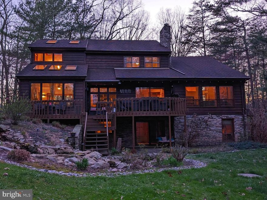 This Canadian designed, contemporary lodge style home sits tucked back in the woods of Fishing Creek Valley. With post and beam construction this home was built to last. The exterior walls are built with 2x6 boards for better insulation... keeping you warm in the winter and cool in the summer. The design is contemporary but still has that cozy, home feeling. With its mature landscaping it's really a site to see in full spring bloom.
 
When you enter the home you walk through the large foyer and into the main living space, covered in hardwood floors and ahead of its time, it's almost entirely an open design concept. There's no shortage of views and natural light, windows line the back of the house. If you love to entertain that won't be a problem with this many gathering spaces. The main living room has cathedral ceilings so plenty of room for that extra-large TV, perfect for game days. The kitchen has a brand new refrigerator and state-of-the-art induction cook-top. You can watch the beautiful birds fly in and enjoy their feeders out the window over the sink, making those dishes a little more bearable. The sunroom is beautiful and functional any time of the year!
 
Upstairs is fully carpeted and features a cozy little loft that overlooks the living room. The two secondary bedrooms are to the front of the house and are of equal size. A full bath with double vanity is at the end of the hall. On the back side of the house is the primary suite complete with a shoe closet, walk-in closet, full tile walk-in shower, soaking tub and double vanity.
 
The fully finished walk-out basement is where you'll find a second living room with a large glass sliding door with access to a patio and backyard. You'll also find a large utilities closet with the washer and dryer. The fourth bedroom, currently being used as an office is downstairs as well. Great for a guest room, it has its own entrance, a walk-in closet and attached half bath.
 
Exit to the backyard and you'll see it's not just woods but has grass and room to play. A lovely fish pond with stone waterfall add to the perfect background noise to serene ambiance. To the very back of the property is a brand new shed with a storage loft and rot resistant flooring. The well camouflaged and beautifully landscaped sand mound flanks the right side of the home near the two car garage. Making for an extra lovely part of the yard, instead of the typical eye sore. With another utility shed attached to the garage this home has no lack of storage inside or out. If you're looking for a quiet, spacious, unique, well-built, well-maintained and manicured home... surrounded by nature, this is for you! Come make it yours.
 
Other things to note: New Anderson Windows and Doors throughout. New water heater, water pump, refrigerator, induction cook-top, washer, dryer and shed. All replaced within the last 5 years. 12 year old roof.
 
Listing Agent is related to sellers.