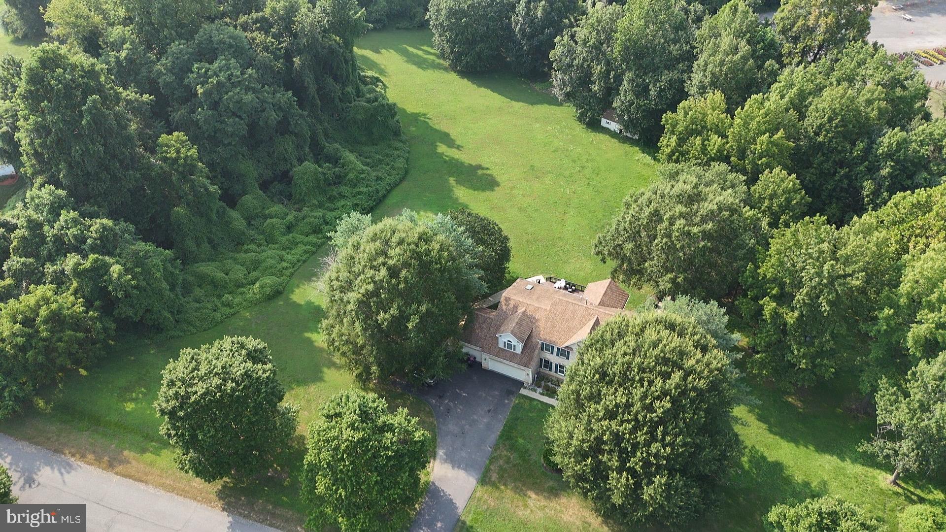 Assumable 3.25% FHA mortgage for a spectacular 6BR 3.5BA estate on almost 4 acres of manicured lawns! Move-in ready - just in time for school. The perfect location to entertain family and friends. The home is currently also a short-term rental averaging $84,000 per year. If space is what you want, space is what you will find - inside & out - at this home! The main level offers an inviting foyer and formal living, dining room, office, grand family room with vaulted ceiling, powder room and sunroom with sweeping views of the expansive outdoor living space. The beautiful kitchen offers a workplace to create the most exciting culinary delights. It features a large island, ample granite counter space with multiple prep areas, and 42-inch custom cabinets surrounding stainless steel appliances. The upper-level primary bedroom is spectacularly expansive, occupying an entire wing and boasting a vaulted ceiling, sitting, exercise, and work areas. Over 1700 square feet on the lower level is complete with 3 large bedrooms, a full bath, a large laundry room, an exercise/recreation area, home theatre viewing area, and a large storage room. Relax and enjoy the private, serene outdoors while grilling with friends on the expansive deck, playing basketball on the finished basketball court, watching your children play on the outdoor play equipment or in the fun treehouse or making smores at the fire pit. There’s also an onsite dog kennel for your pups to get fresh air and a large shed that can become a He-shed or She-shed with your special touches! Kilby Court in Claggett Landing Estates can match your family's lifestyle if you're looking for a private retreat to come together with family and friends, make memories and have fun! Ask about gap financing. Lease also considered.
