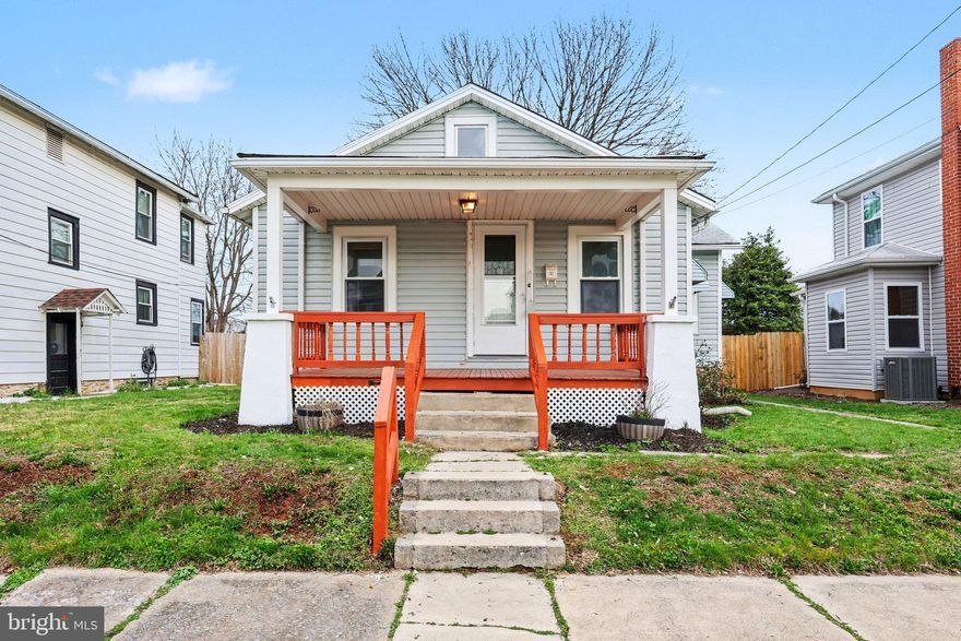 Charming 2-bedroom, 1-bath bungalow in Mechanicsburg Borough featuring a spacious family room addition from 2003, a covered front porch, a deck, off-street parking, and a detached 2-car garage.
