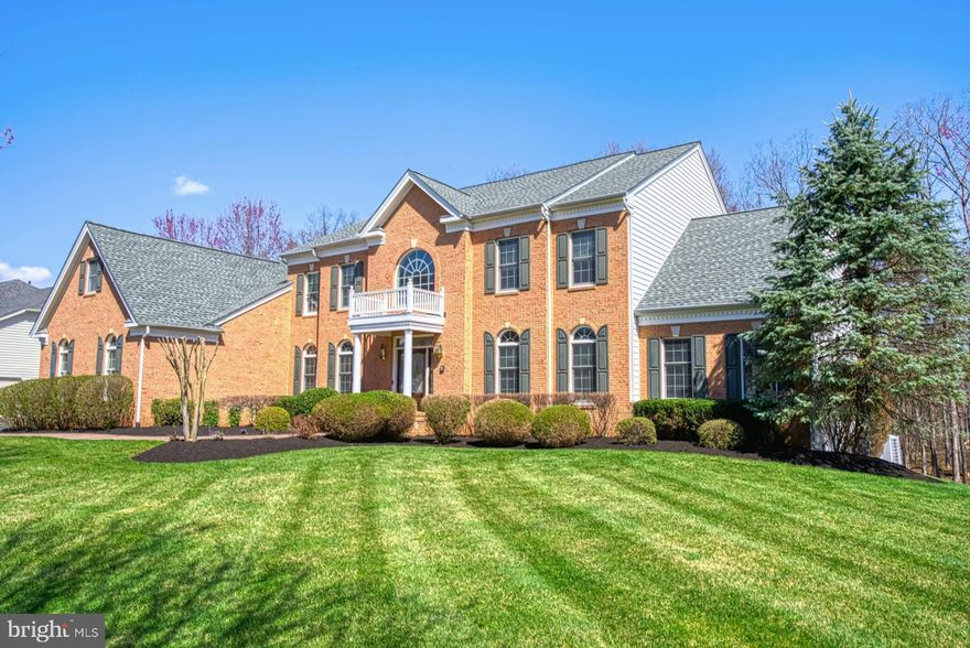 Stately Hampton Estate made for entertaining that backs up to private woods. This home has
8000+ finished square feet on three levels located in the enclave of the much sought-after
Dominion Valley Country Club.  Enter the home's grand foyer with dual staircase that leads into
the soaring two story great room with coffered ceiling and wood burning fireplace.  Showcase your
culinary skills in the main level kitchen with granite countertops, oversized island and cherry
cabinets.  Recently upgraded appliances   include,  combo ThinQ wall oven with convection/microwave, dishwasher, refrigerator,  wine cooler, washer and dryer.
The main level has both a formal living and dining room, along with a study with a built-in cherry bookcase.   The upper level has a large master suite with sitting room, two walk-in closets and spa-like bath; three upper level bedrooms each with private bath.  Two bathrooms have been upgraded within the last month. Hours will be spent in the walk-out finished basement designed for entertaining, complete with custom theater room; the feel of a Tuscan wine closet;  a  "TO-DIE-FOR" custom designed wet bar;  fireplace;  pool table and game areas;  bathroom with walk-in shower; and an extra room with a closet you could use for exercise, playroom, office, etc.
Enjoy outdoor living off the kitchen on a huge TREX deck, plenty of room  for family and friends to enjoy while relaxing to the sounds of nature. Other stand-out features include professional landscaping;  irrigation system; a sitting area off of the walkout basement.   The garage has a professional high-quality floor coating to give it a stylistic edge that matches the elegance of the home.  The garage includes an unused circuit to the left of the irrigation control panel which is pre-wired to the circuit breaker panel area to deliver the current for an EV charger.  
Every day is a holiday in Dominion Valley with community amenities like the Arnold Palmer Golf
course, Fitness Center, Aquatics, Tennis,  Paddleball courts and indoor basketball courts. 
Enjoy the on-site dining at the  beautiful PALMER'S Restaurant.